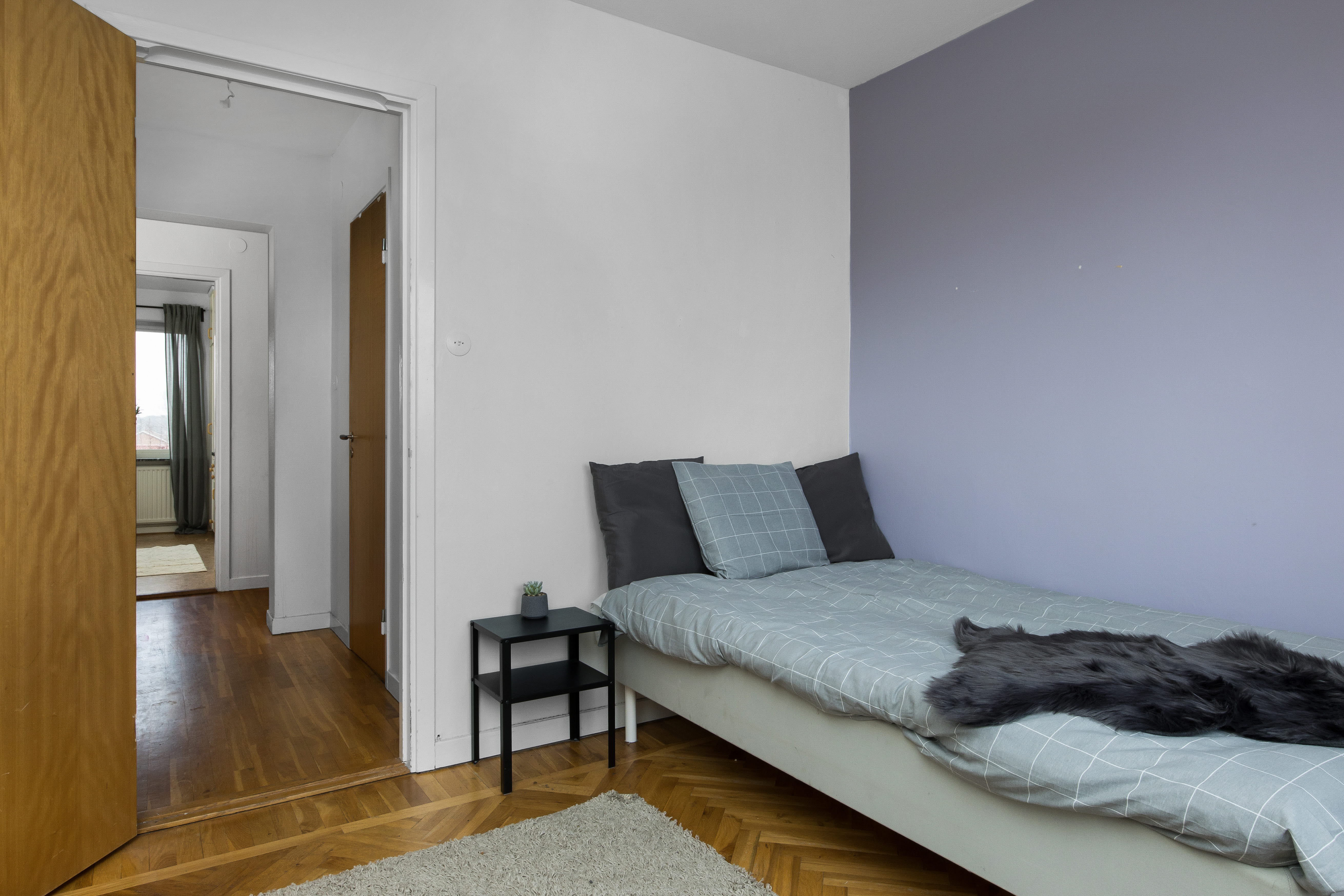 A bedroom with a bed in a room