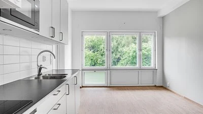 A kitchen with a sink and a window