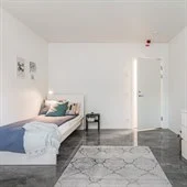 A bedroom with a bed in a room