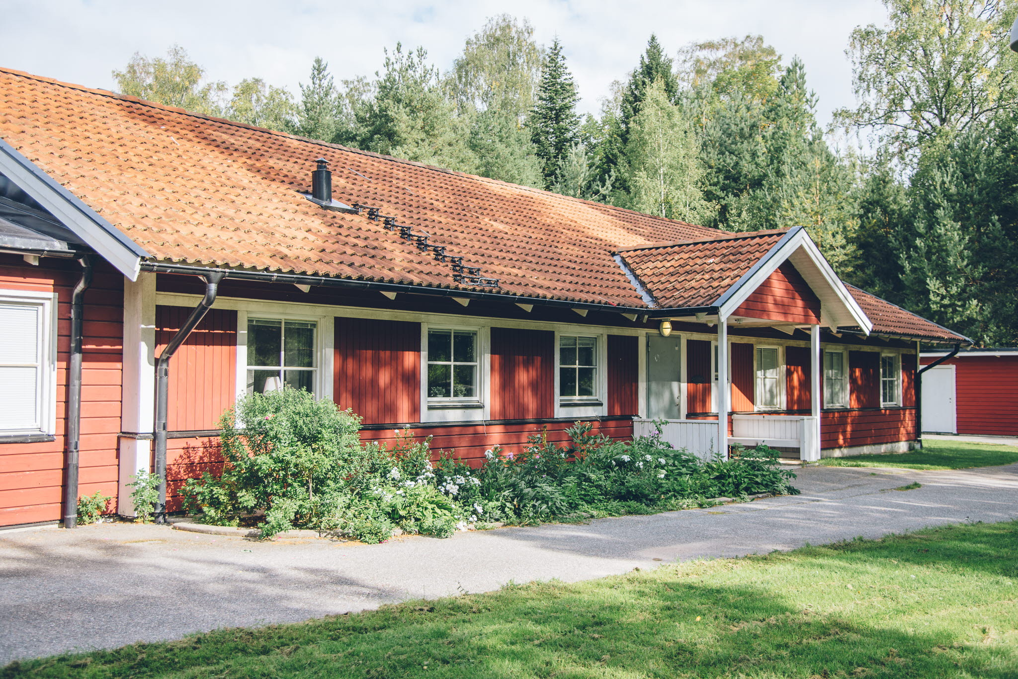 A large brick building with grass in front of a house
