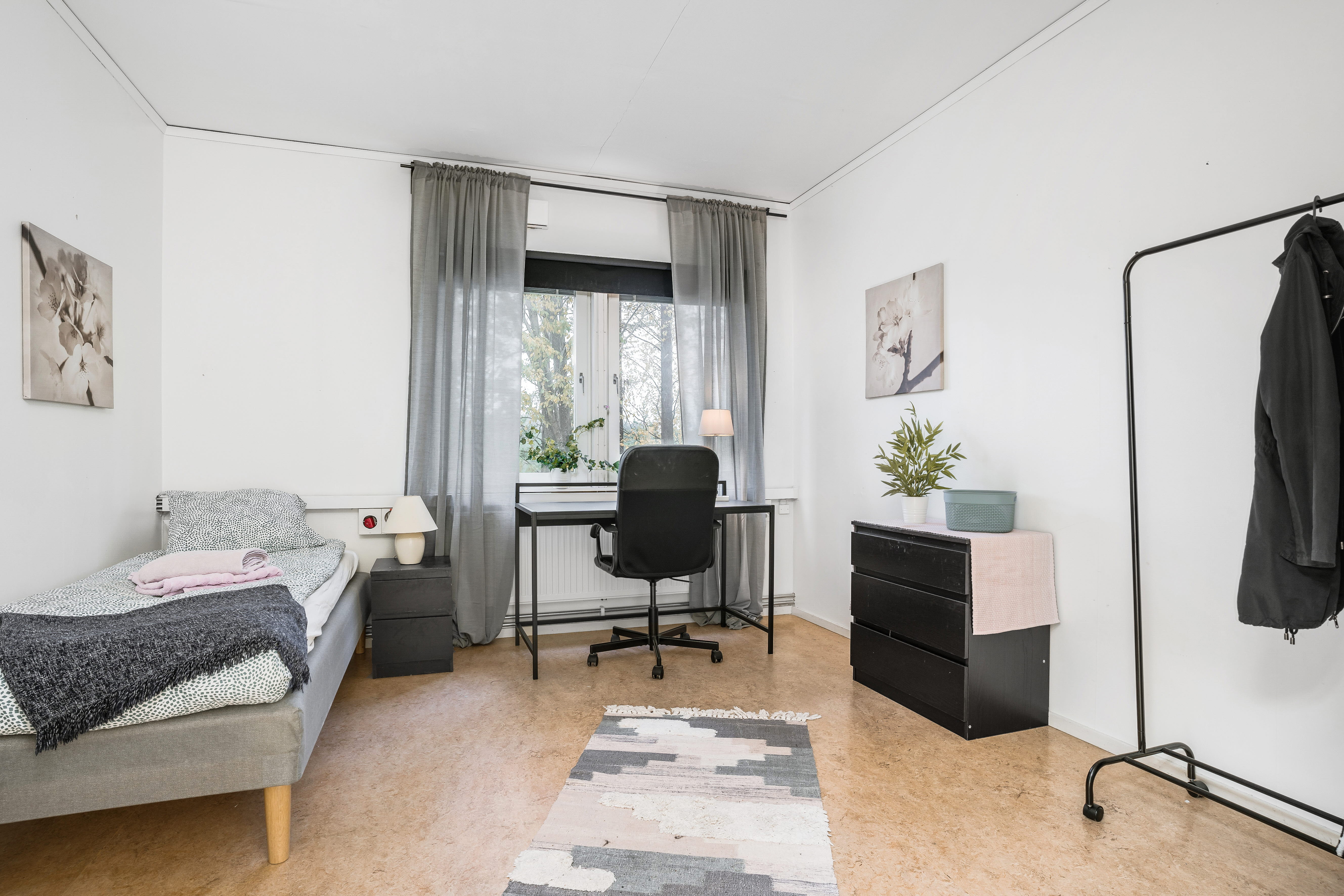 A living room filled with furniture and a large window
