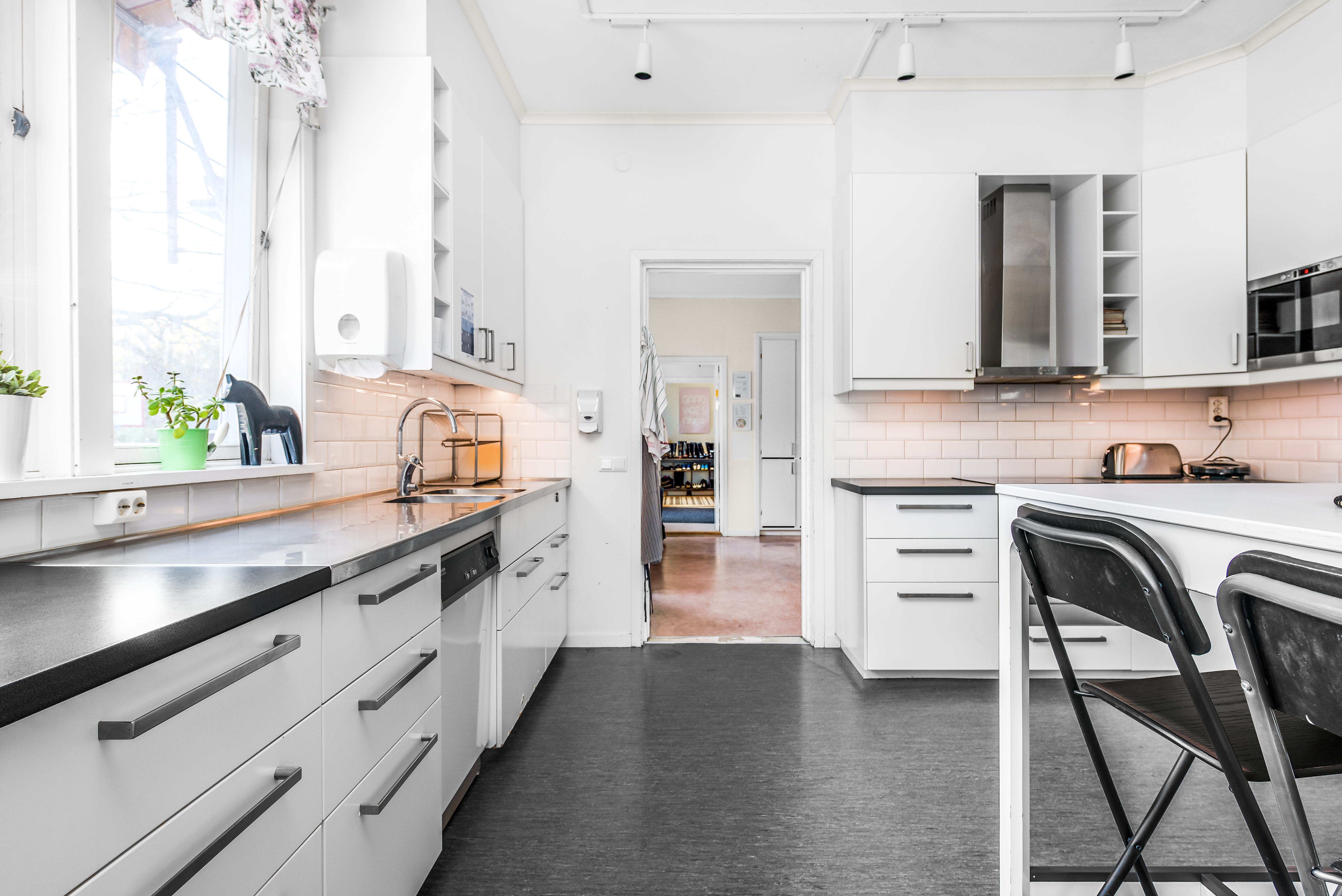 A kitchen with a wooden floor