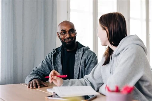 Two people sitting at a table.