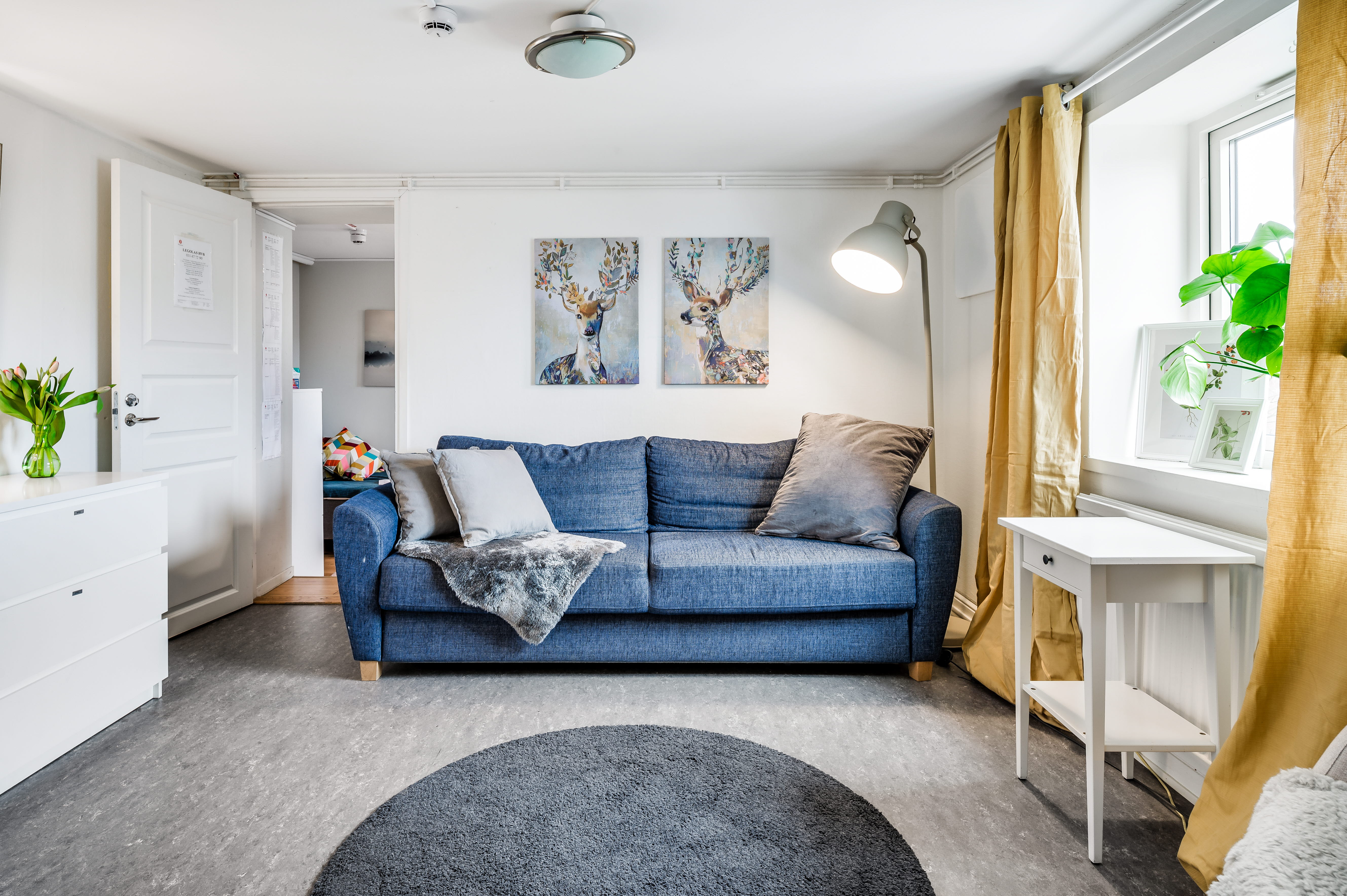 A living room filled with furniture and a large window