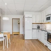 A kitchen with a hard wood floor