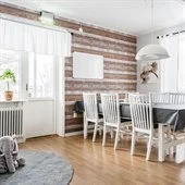 A living room filled with furniture on top of a hard wood floor