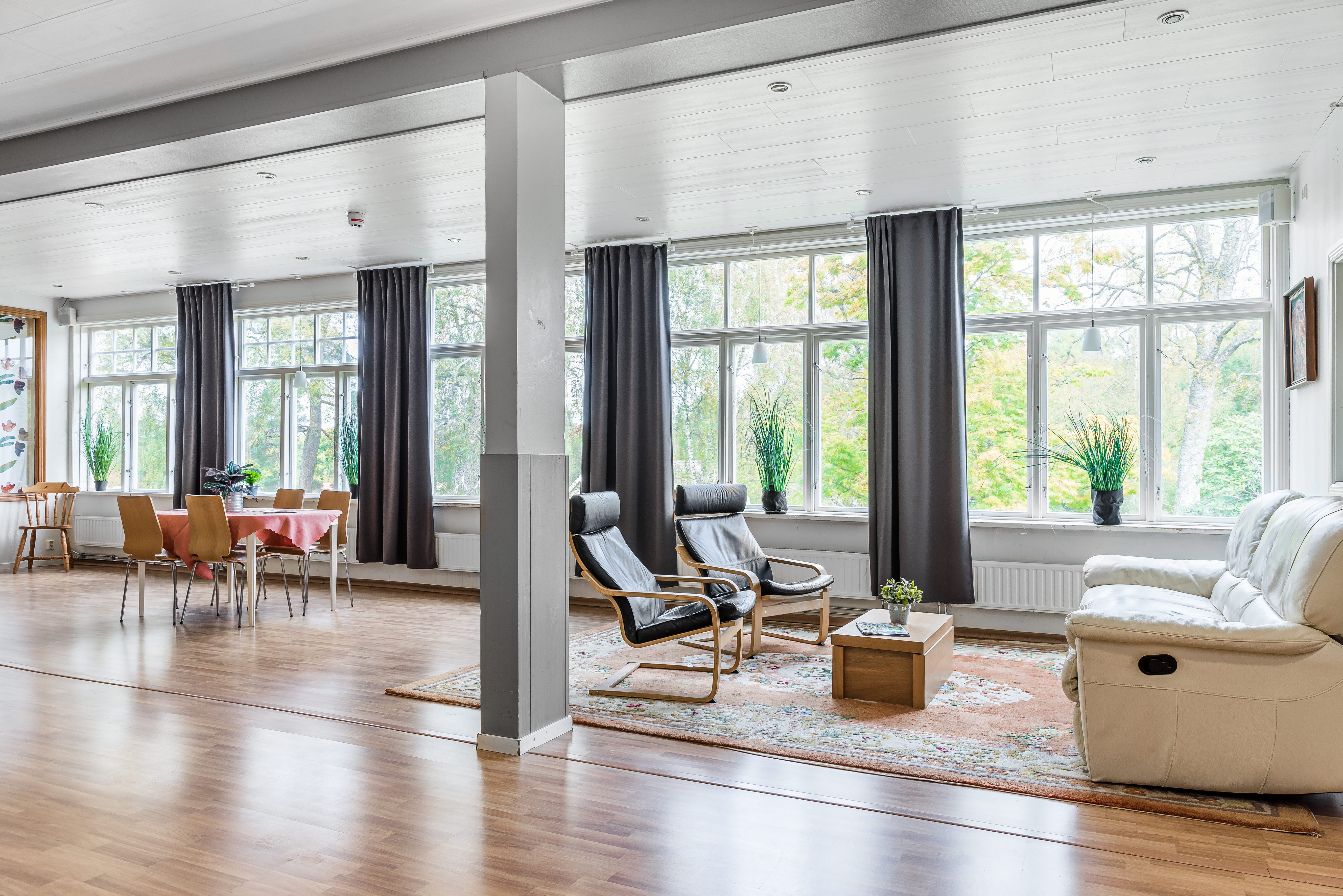 A view of a living room filled with furniture and a large window