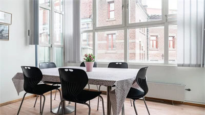 A dining room table in front of a window