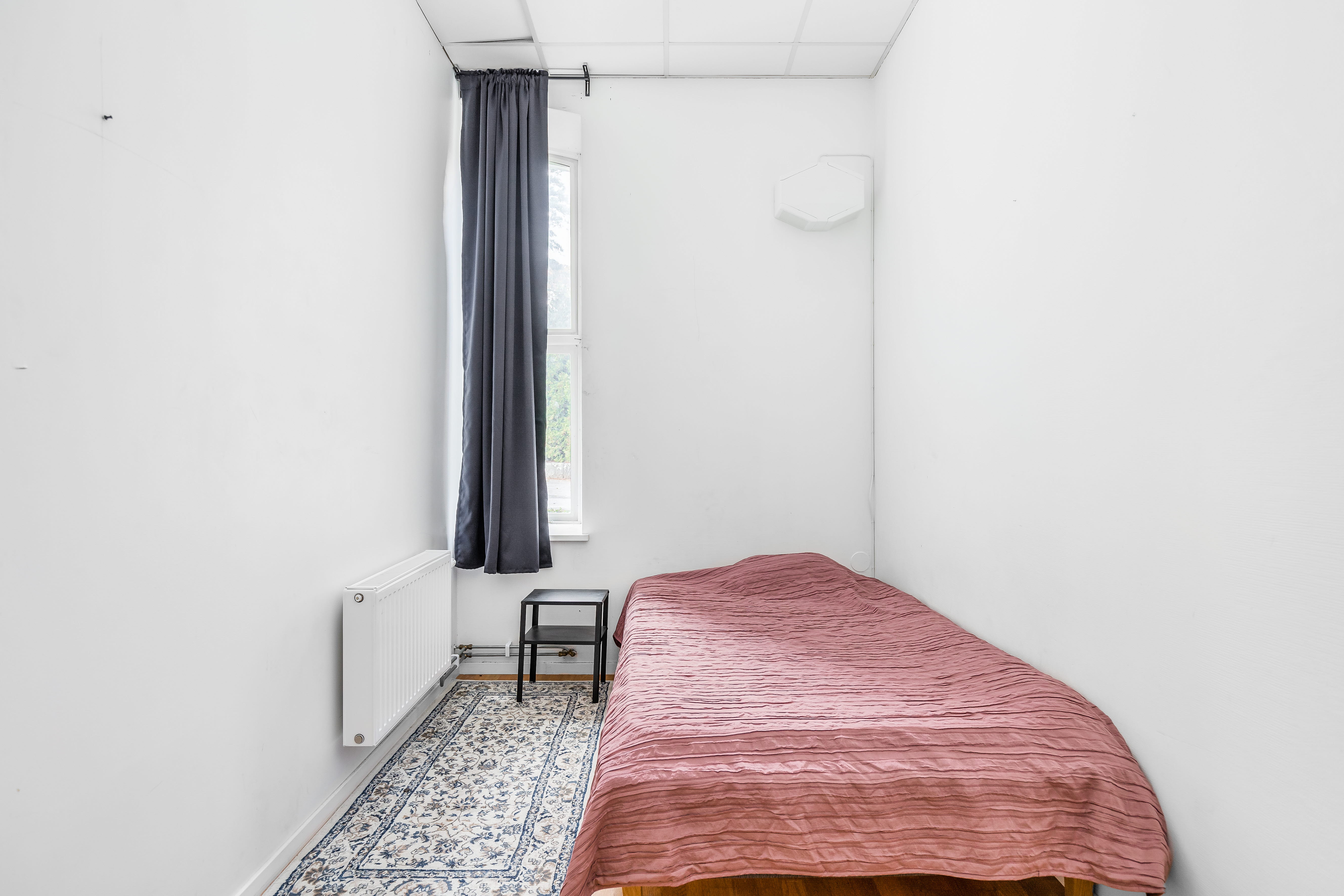 A bedroom with a bed in a room