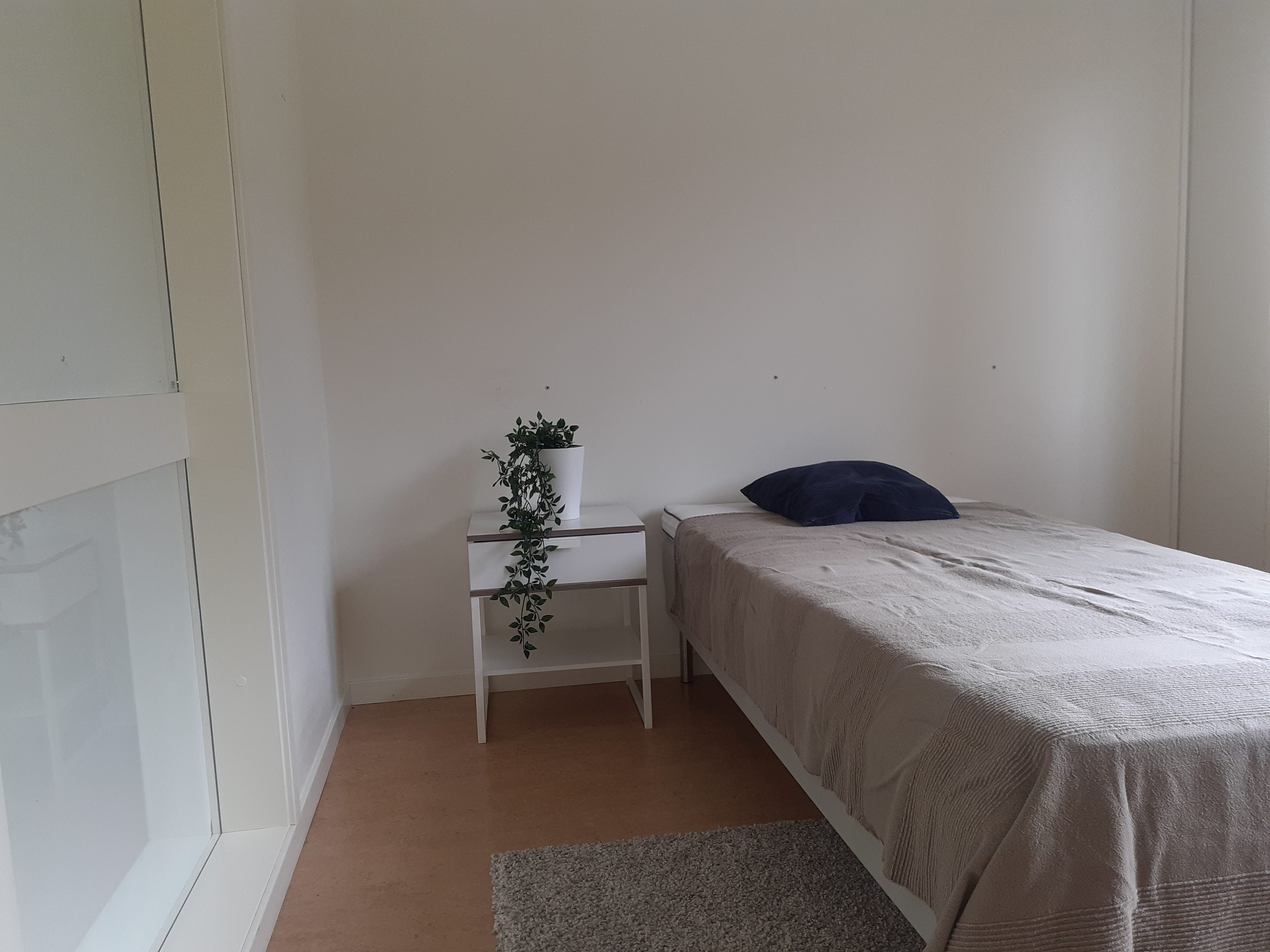 A bedroom with a bed in a room
