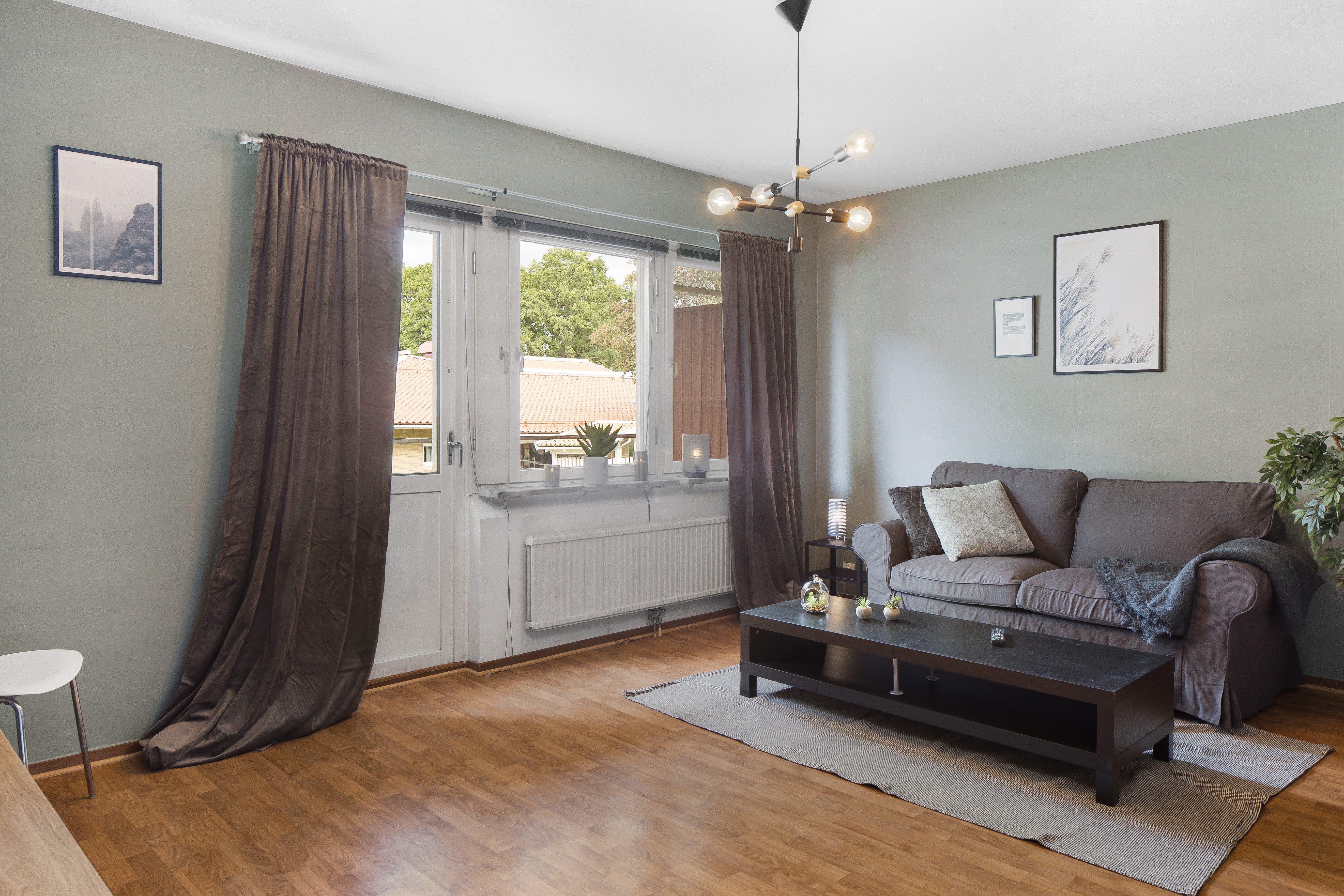 A living room filled with furniture on top of a hard wood floor