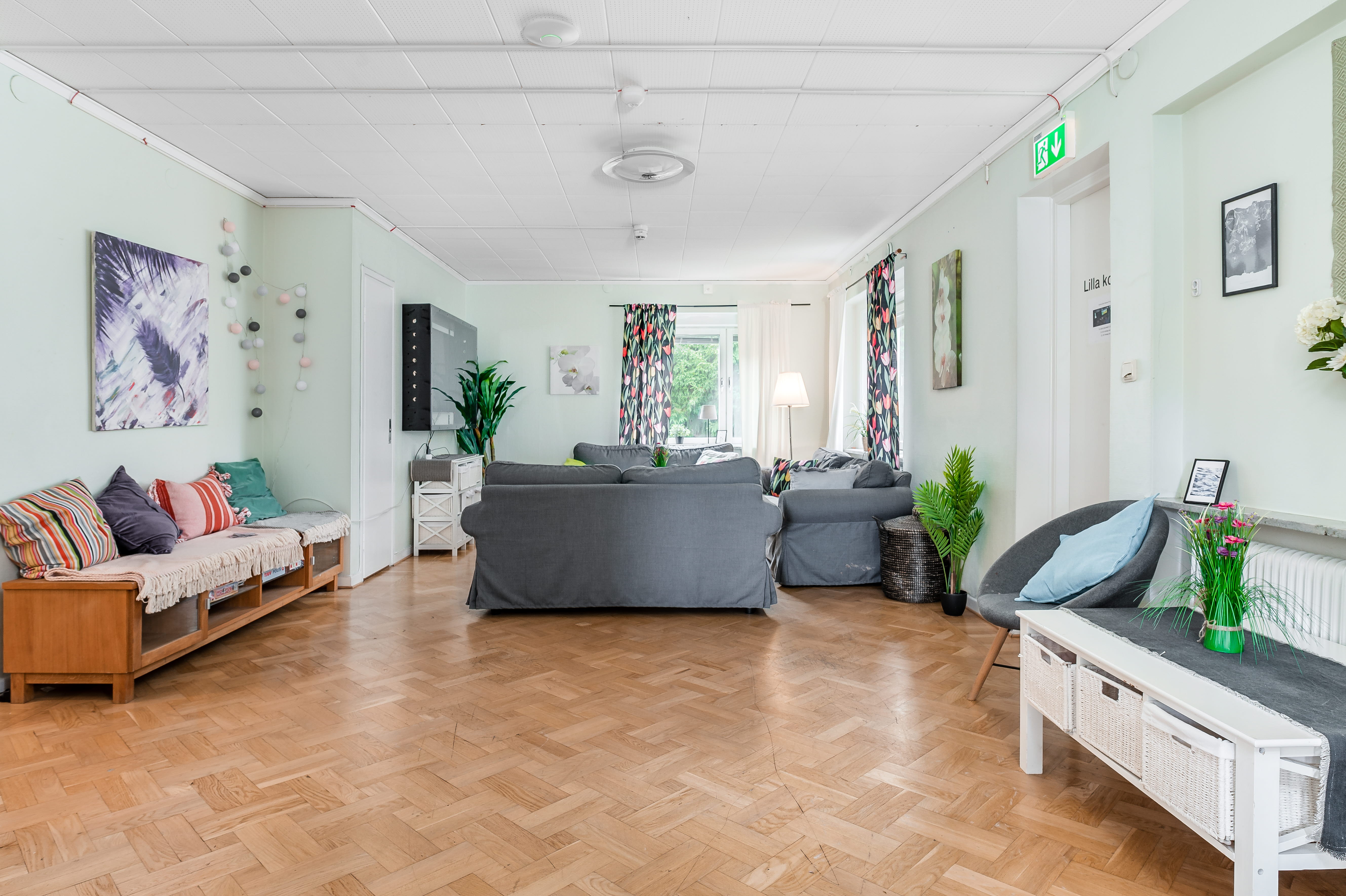 A living room filled with furniture on top of a hard wood floor