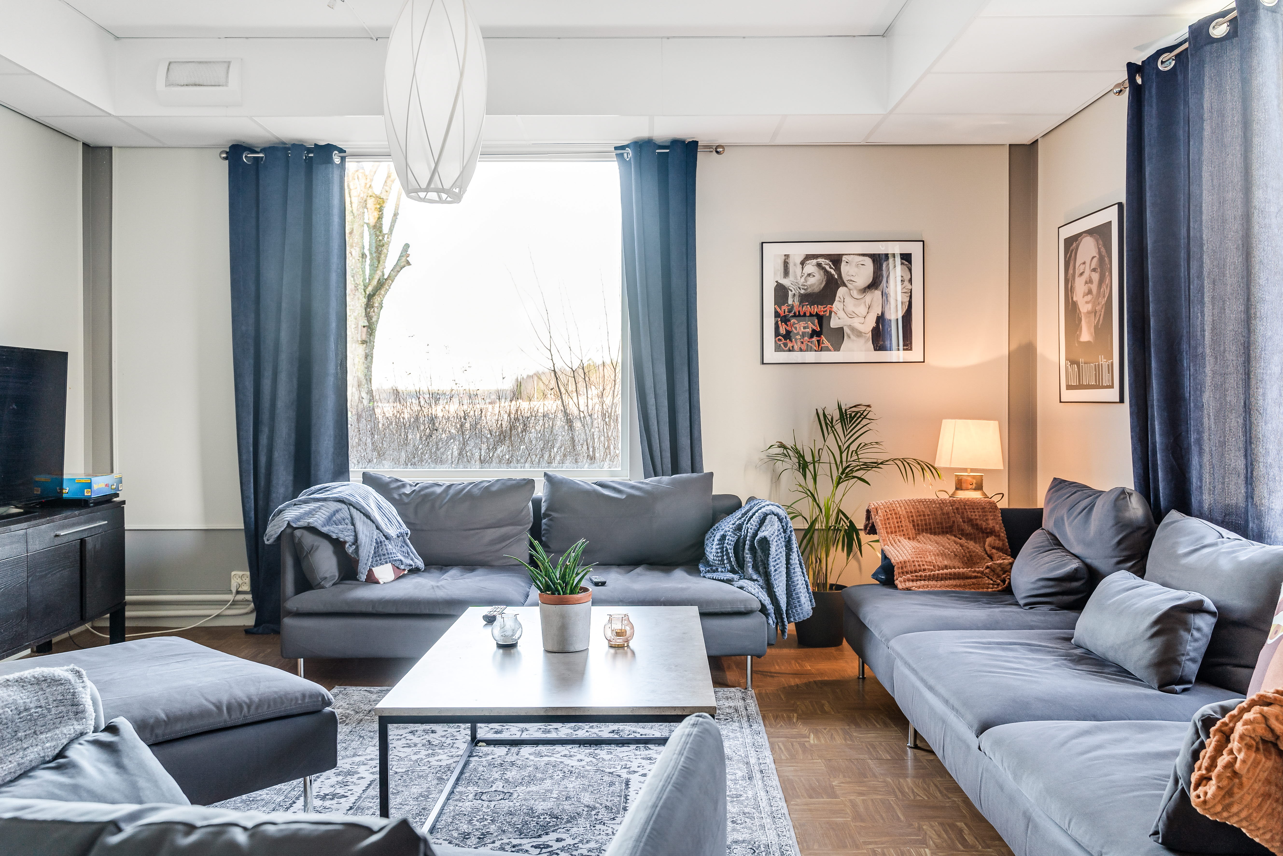 A living room filled with furniture and a large window