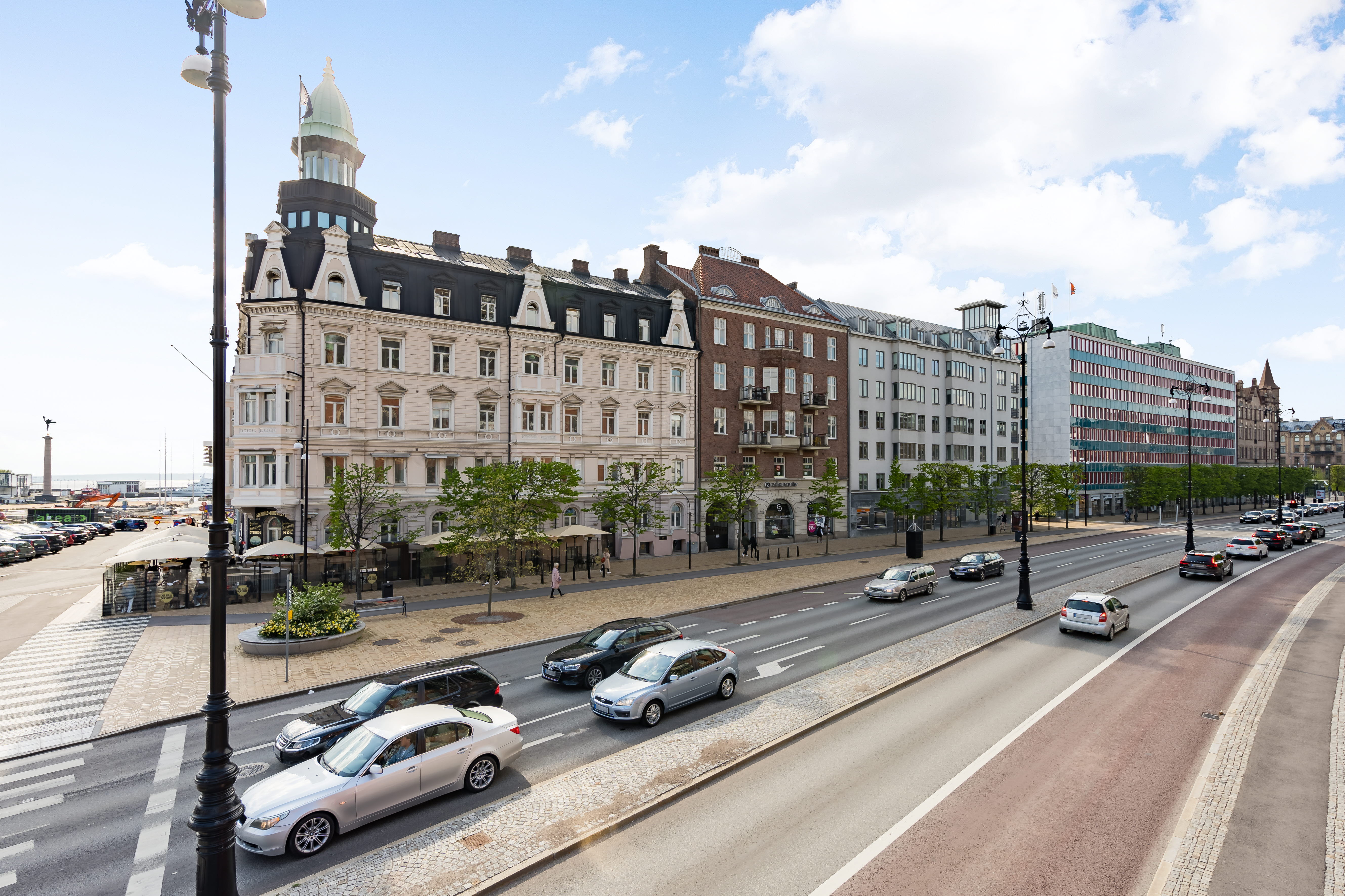 A street with cars parked on the side of a road