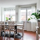A dining room table in front of a window