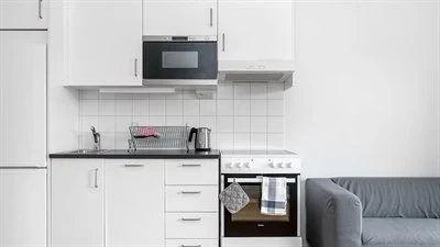 A kitchen with a stove top oven sitting inside of a room