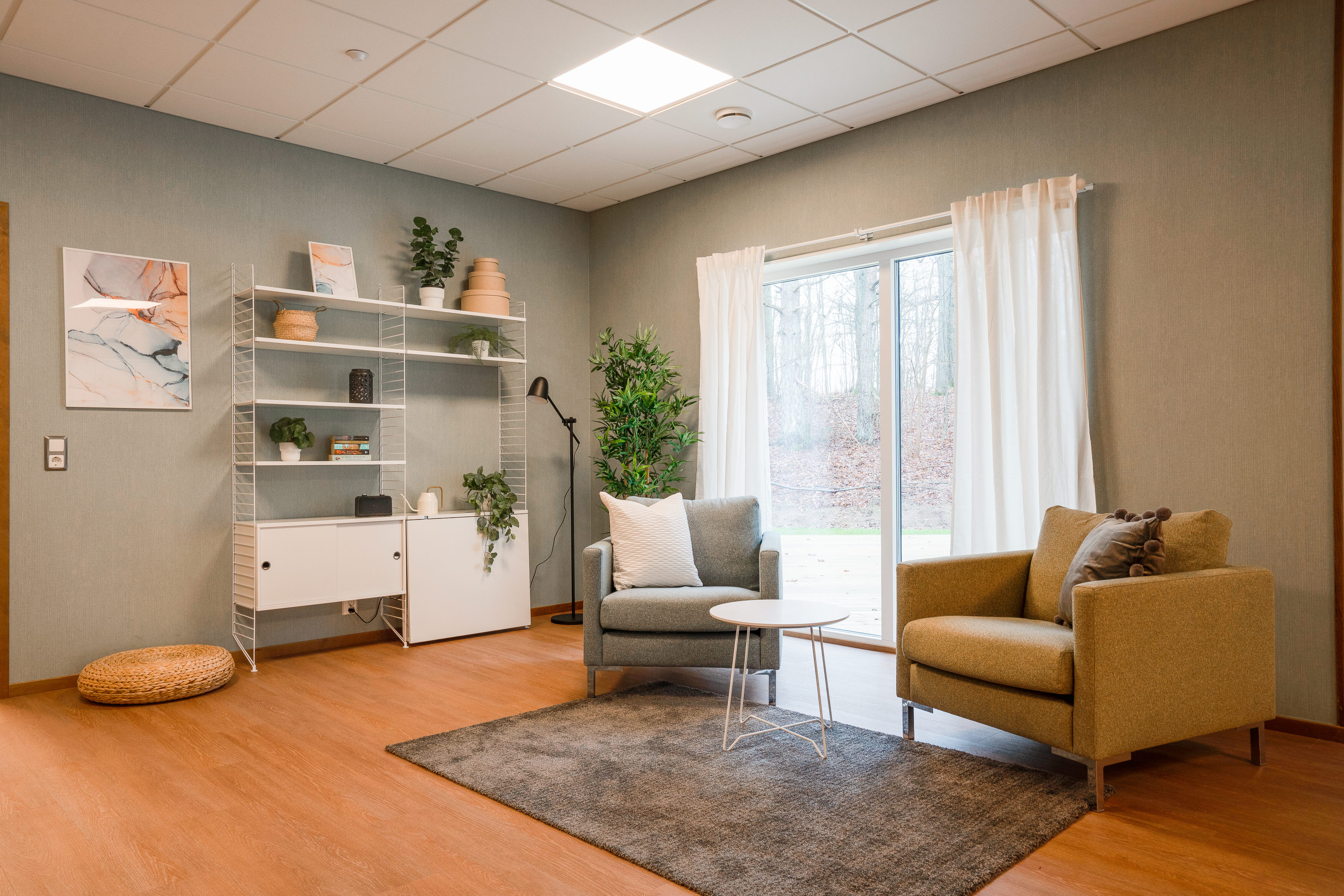 A living room filled with furniture and a large window
