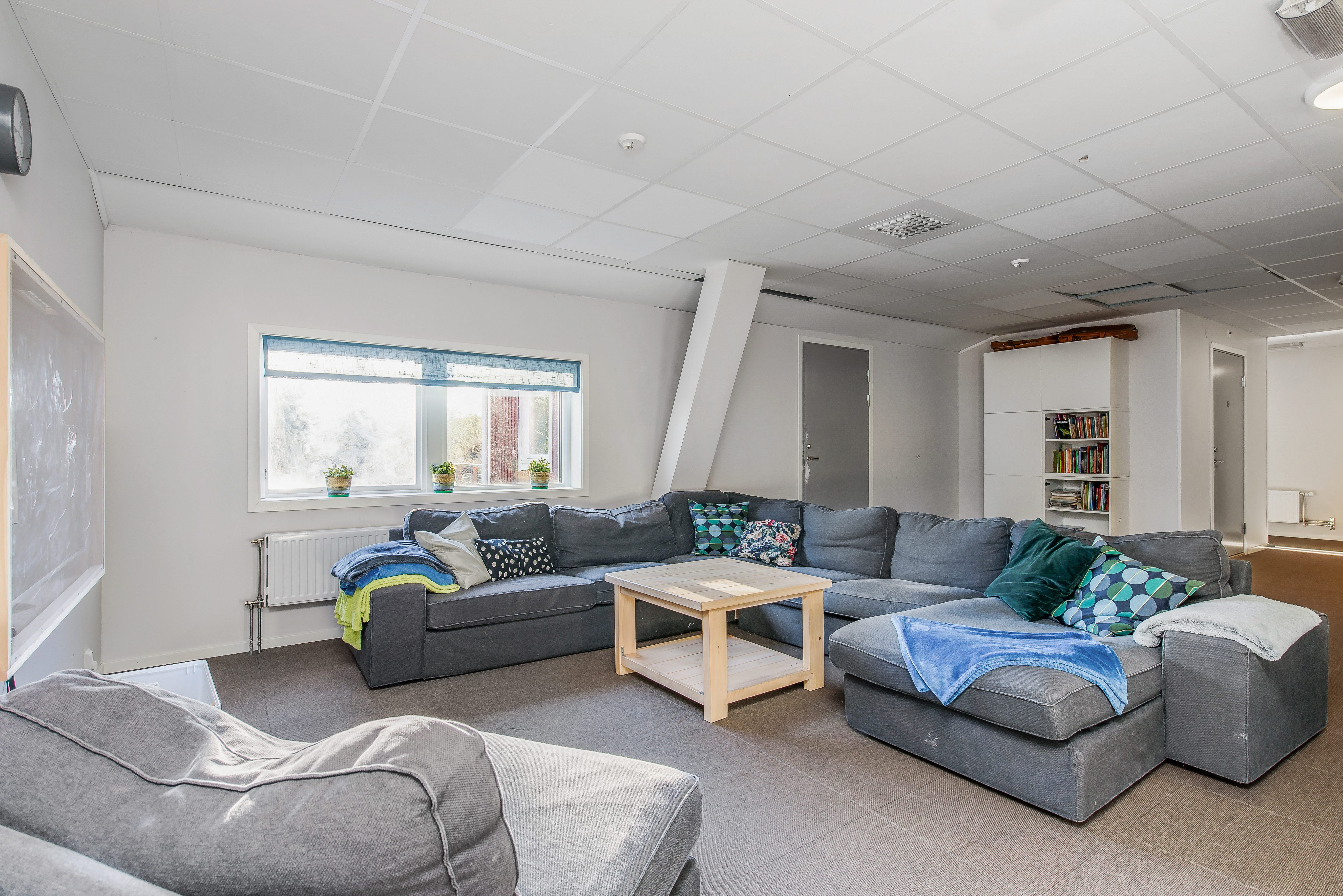 A living room filled with furniture and a large window