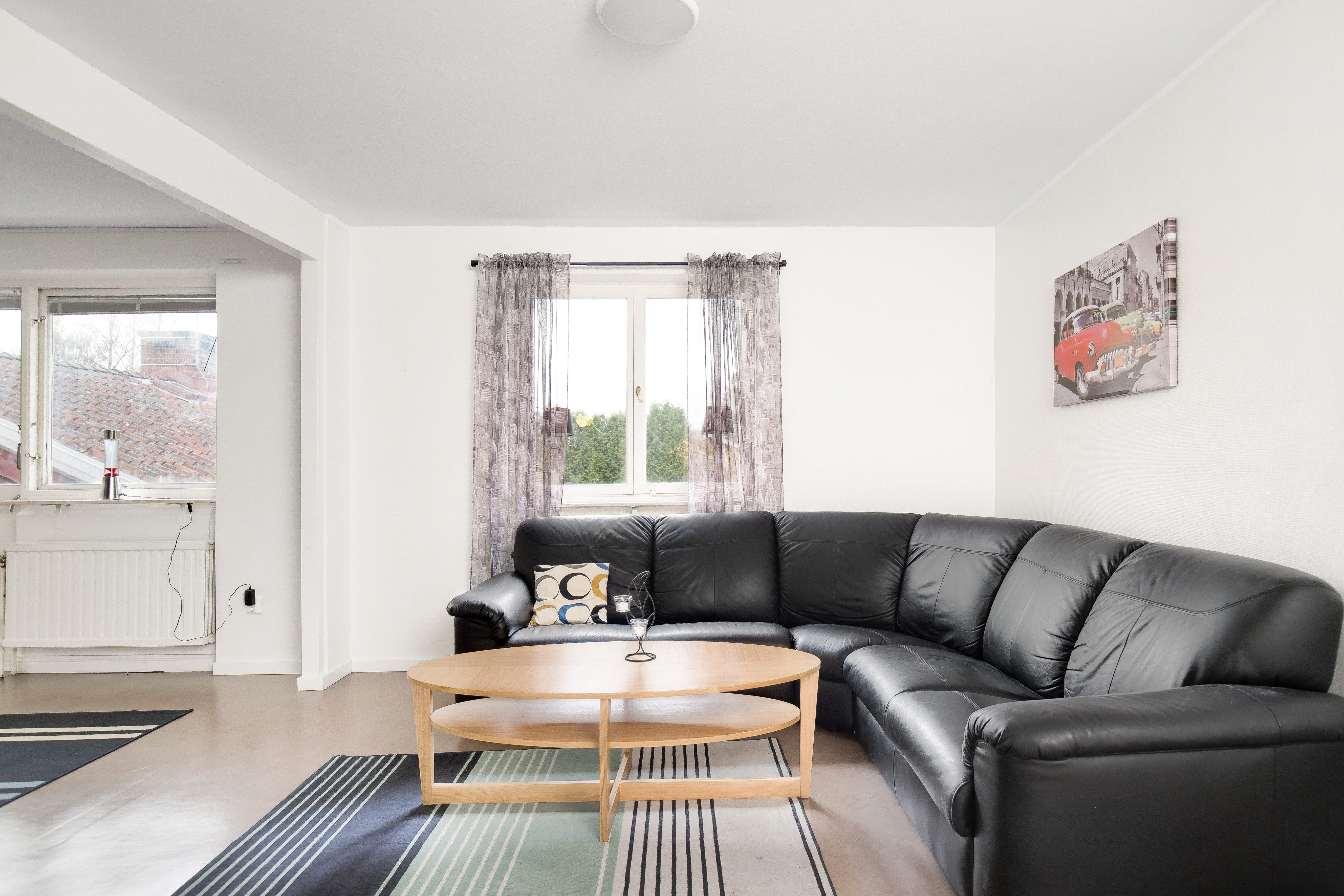 A living room filled with furniture and a large window