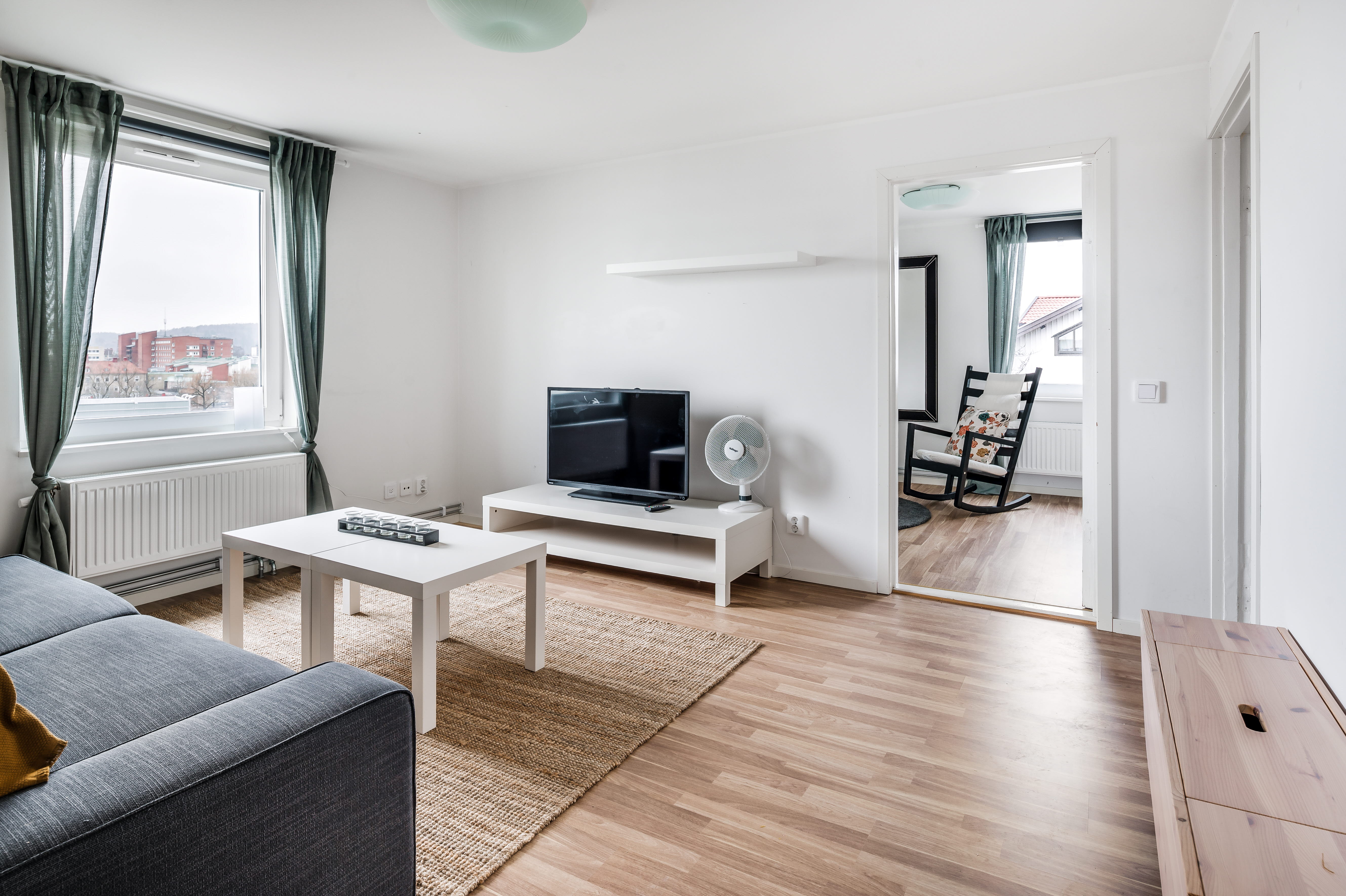 A living room filled with furniture and a large window
