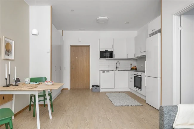 A kitchen with a table in a room