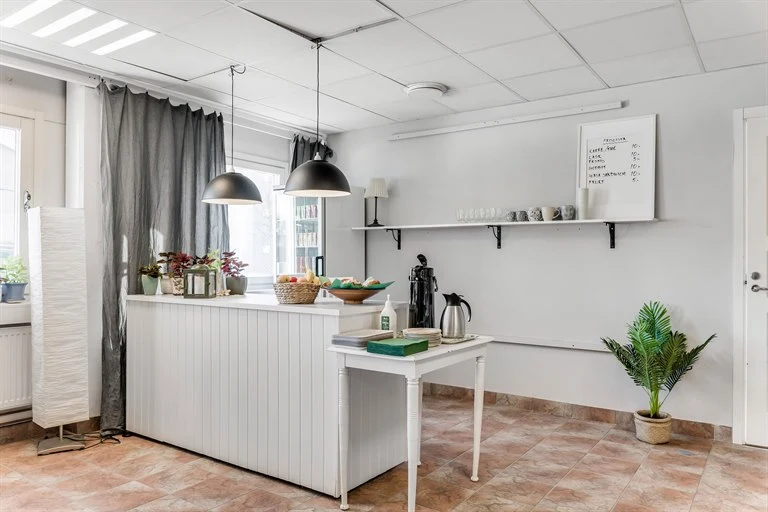 A kitchen with a table in a room