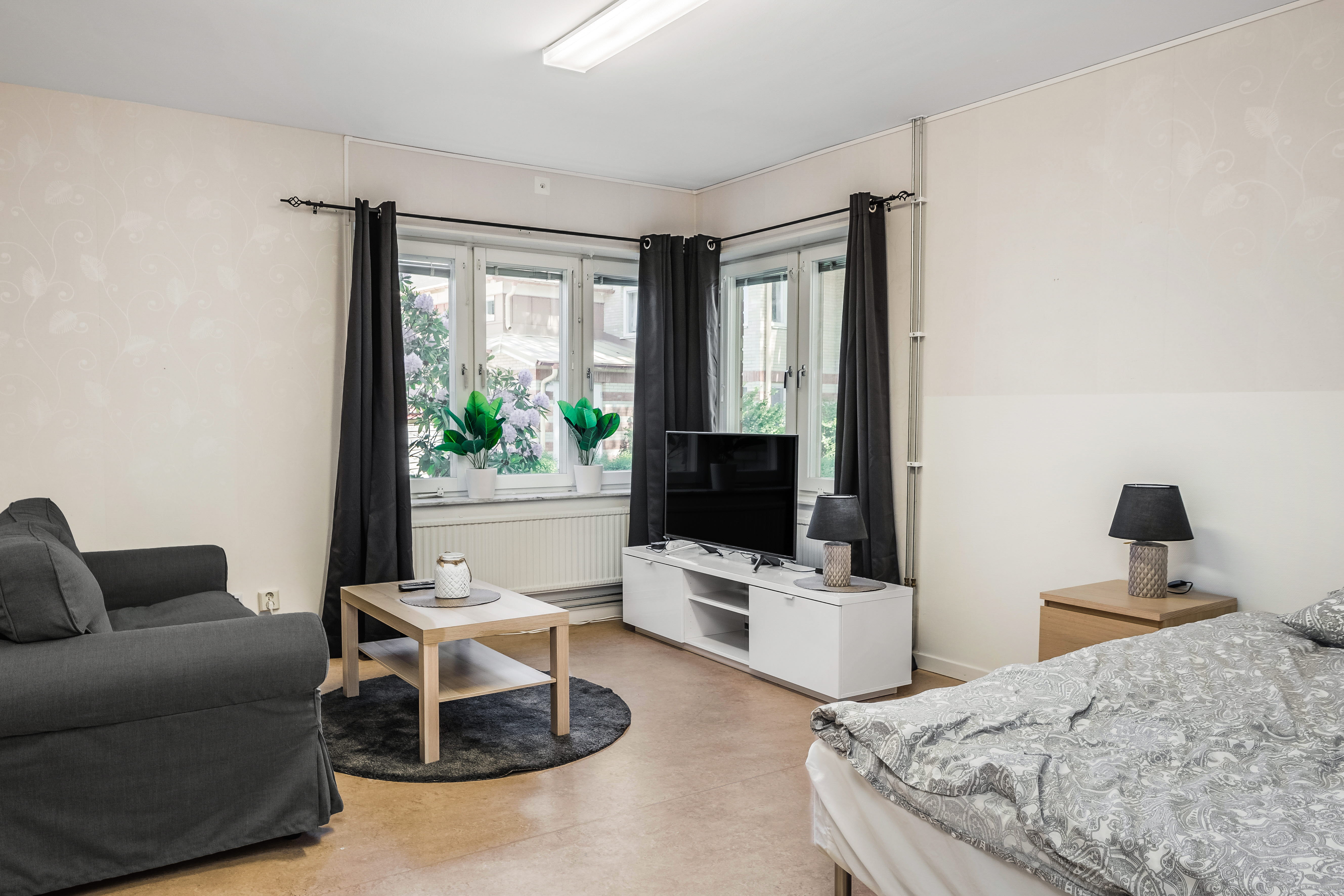 A bedroom with a view of a living room