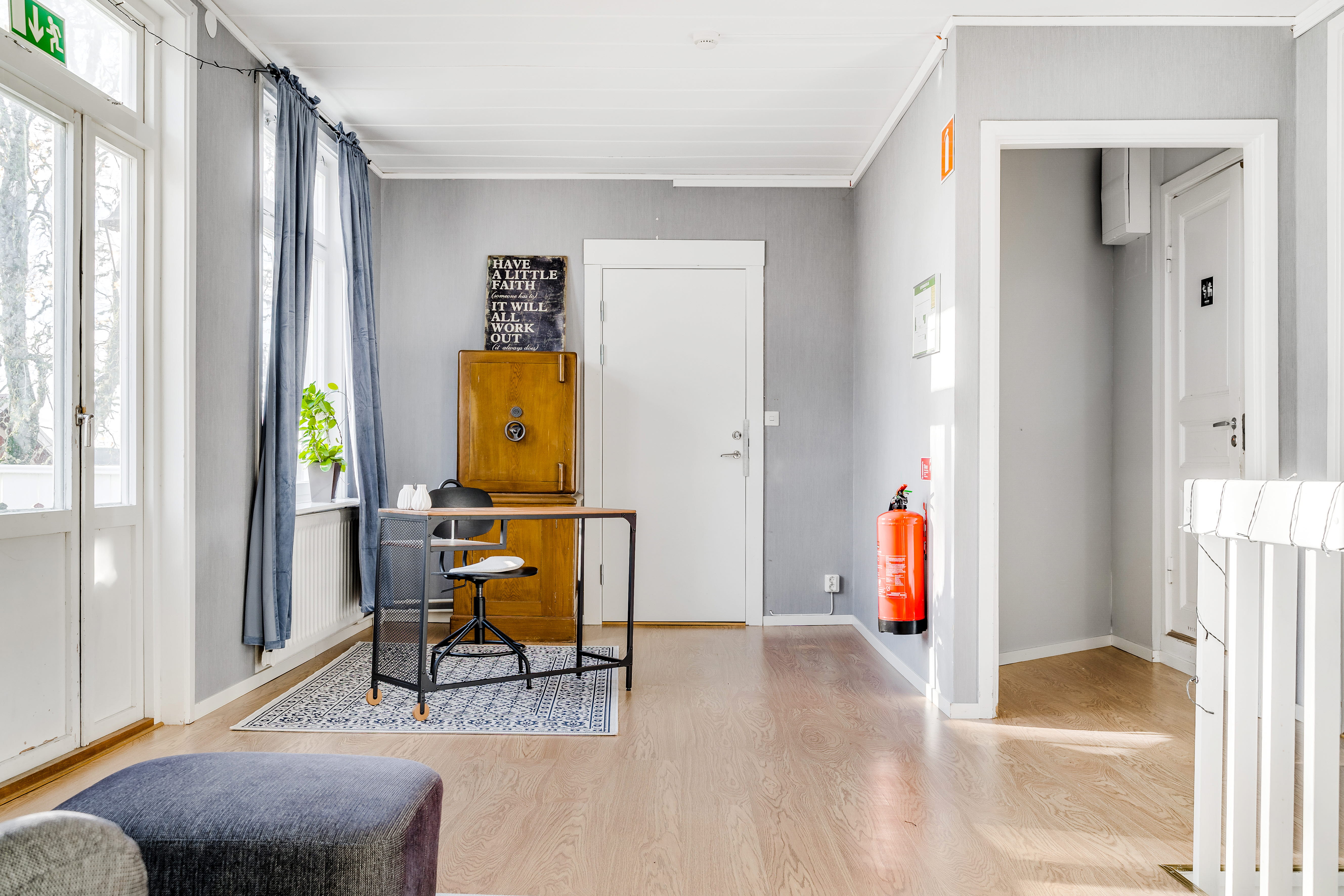 A room filled with furniture and a large window
