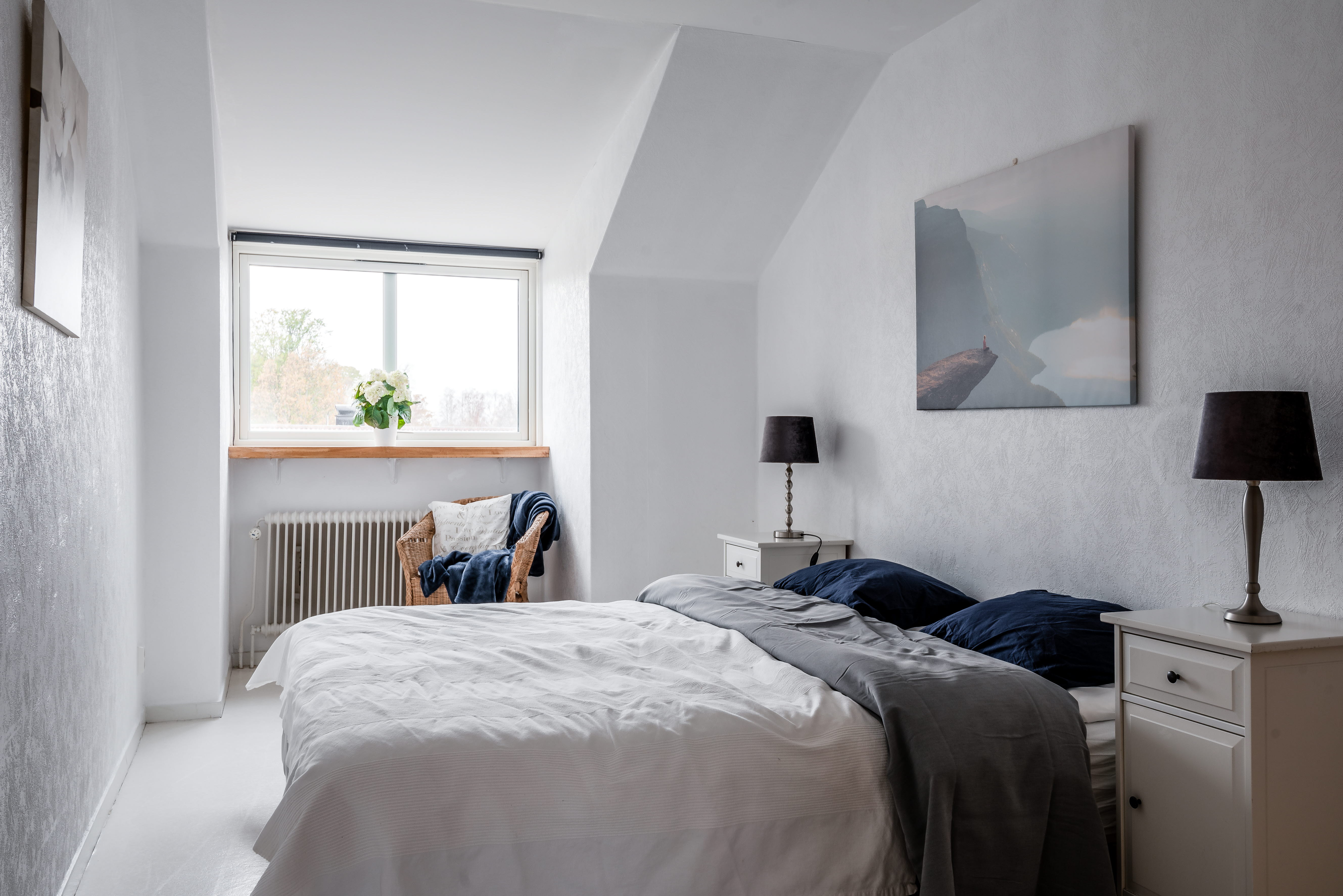 A bedroom with a bed in a room