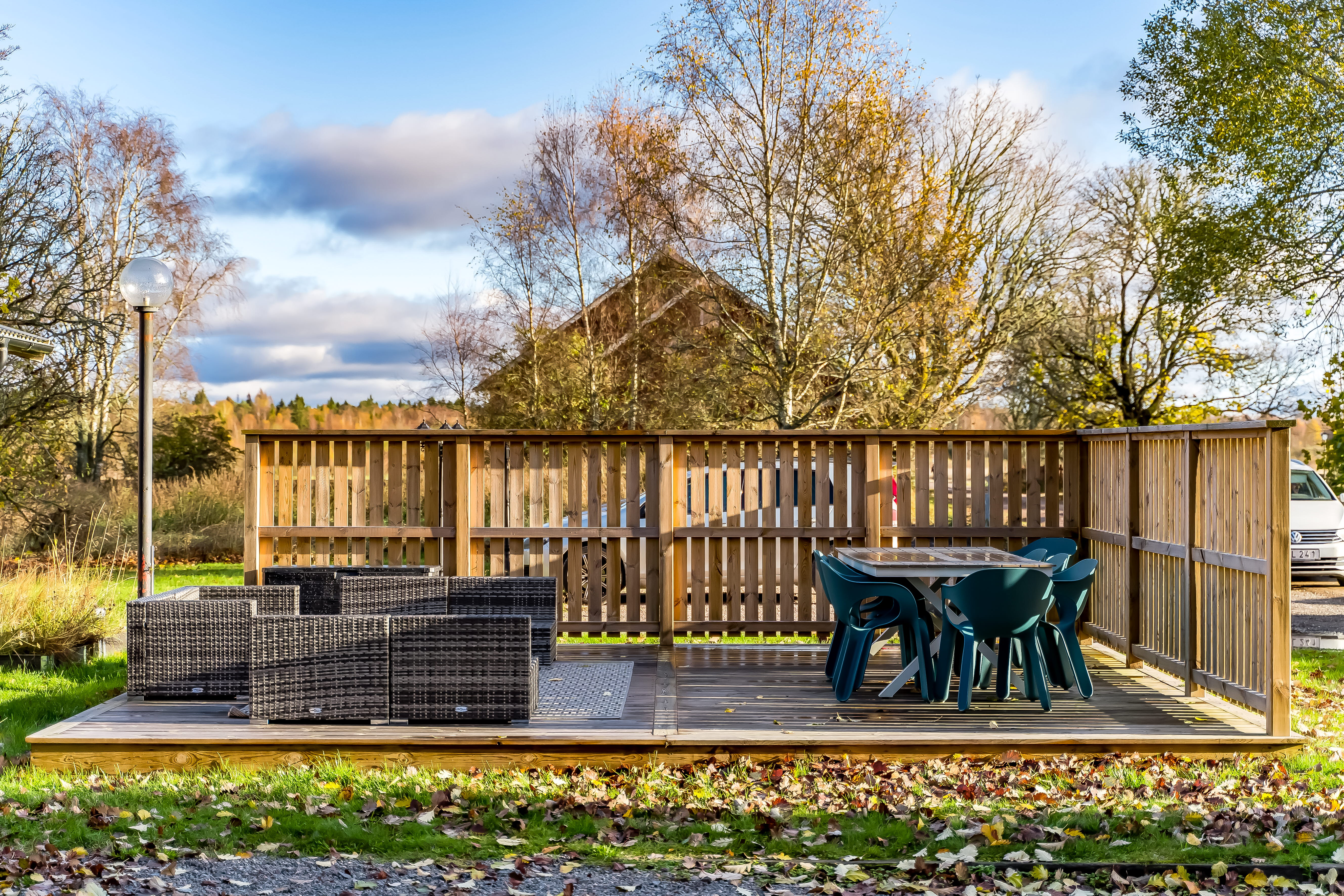 An empty park bench next to a fence