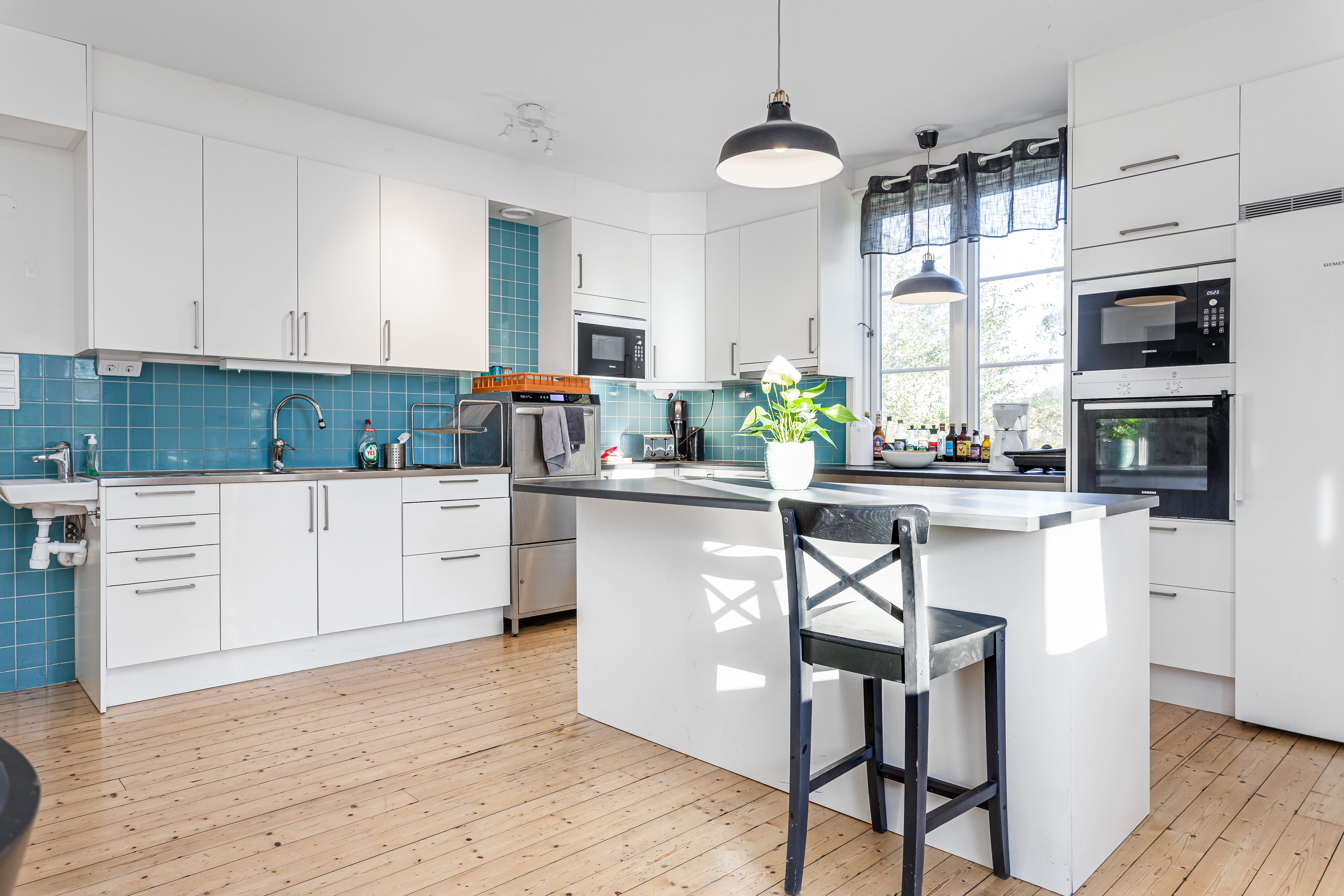 A kitchen with a wood floor