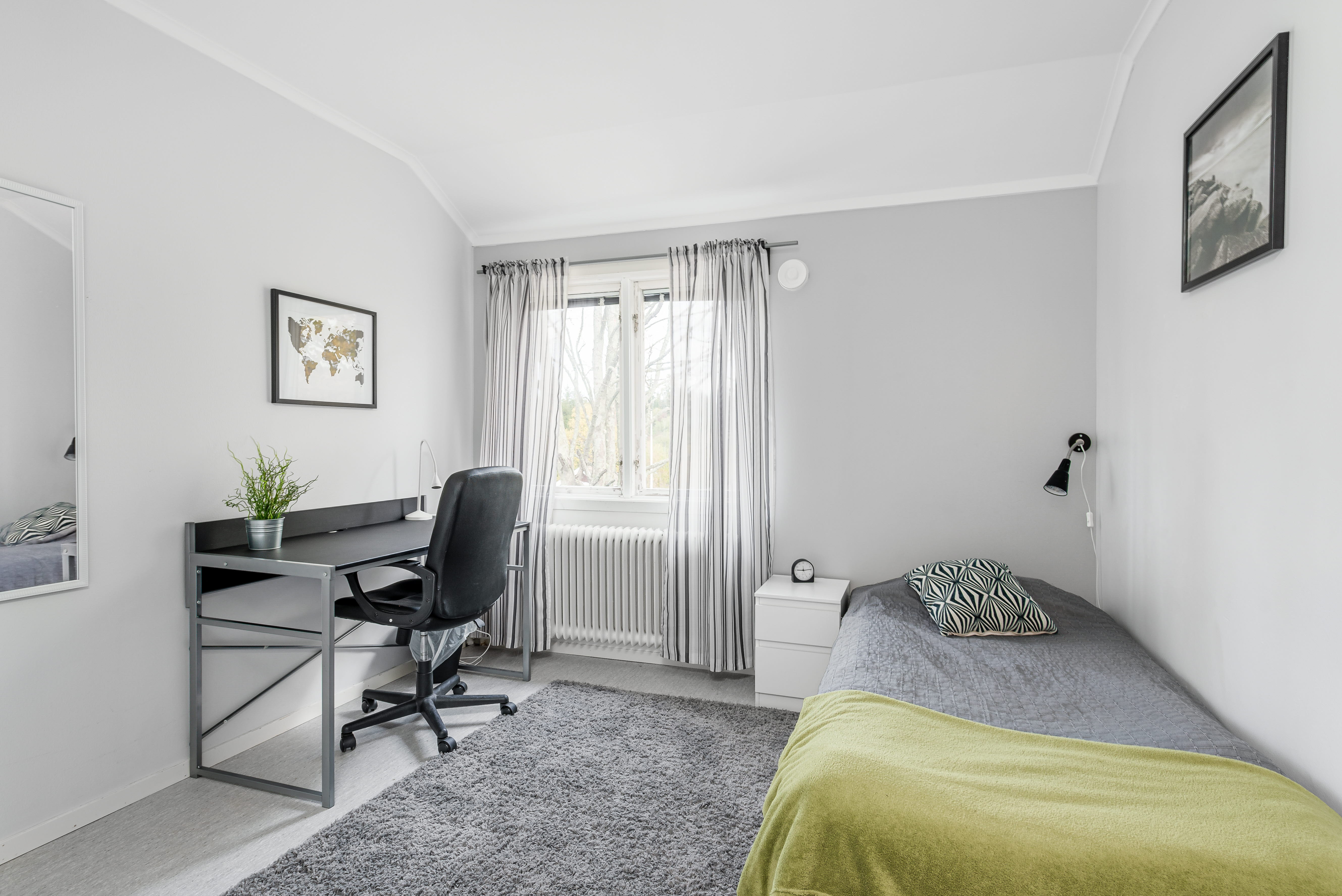 A bedroom with a bed in a room