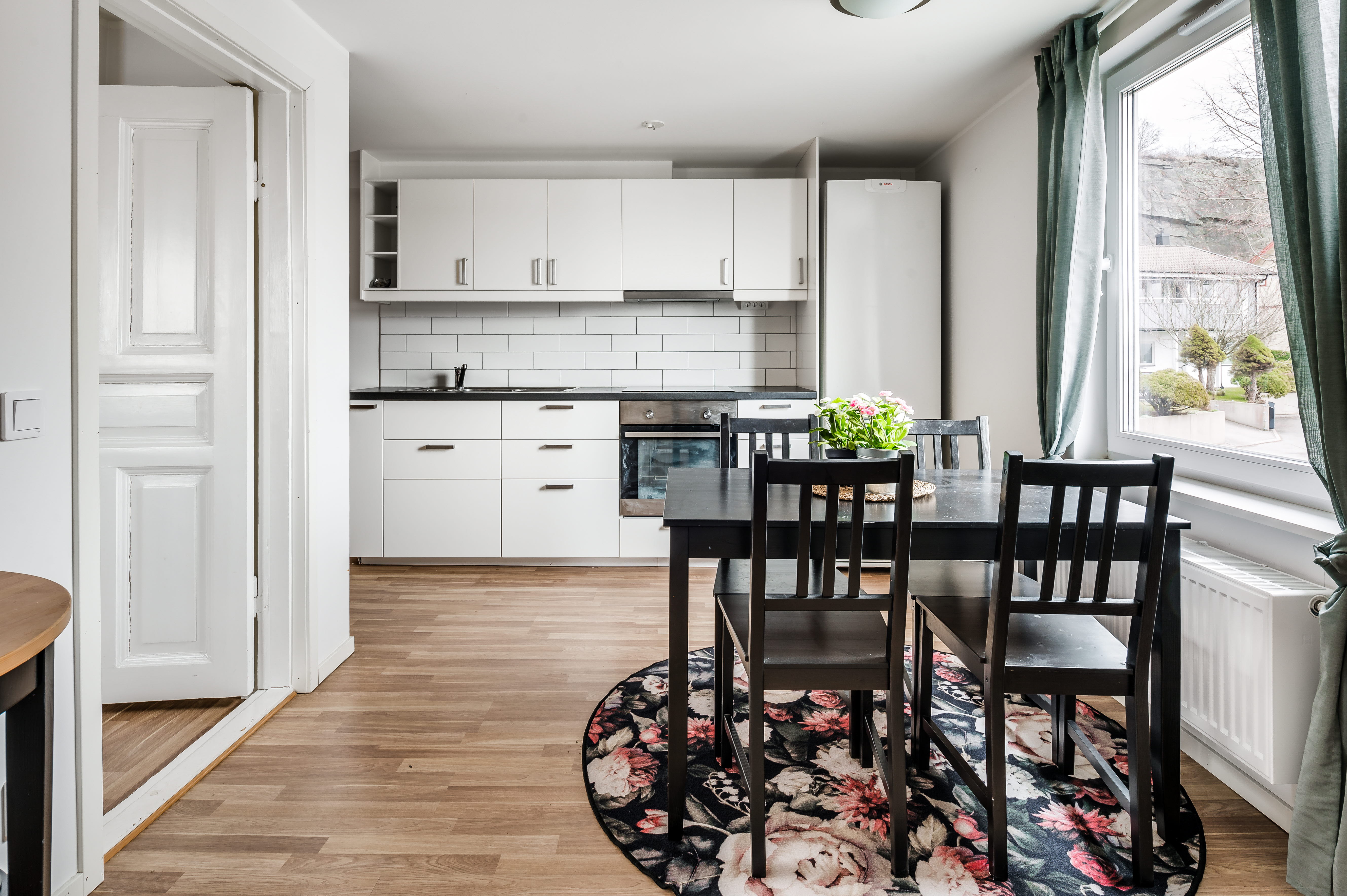 A dining room table in front of a window