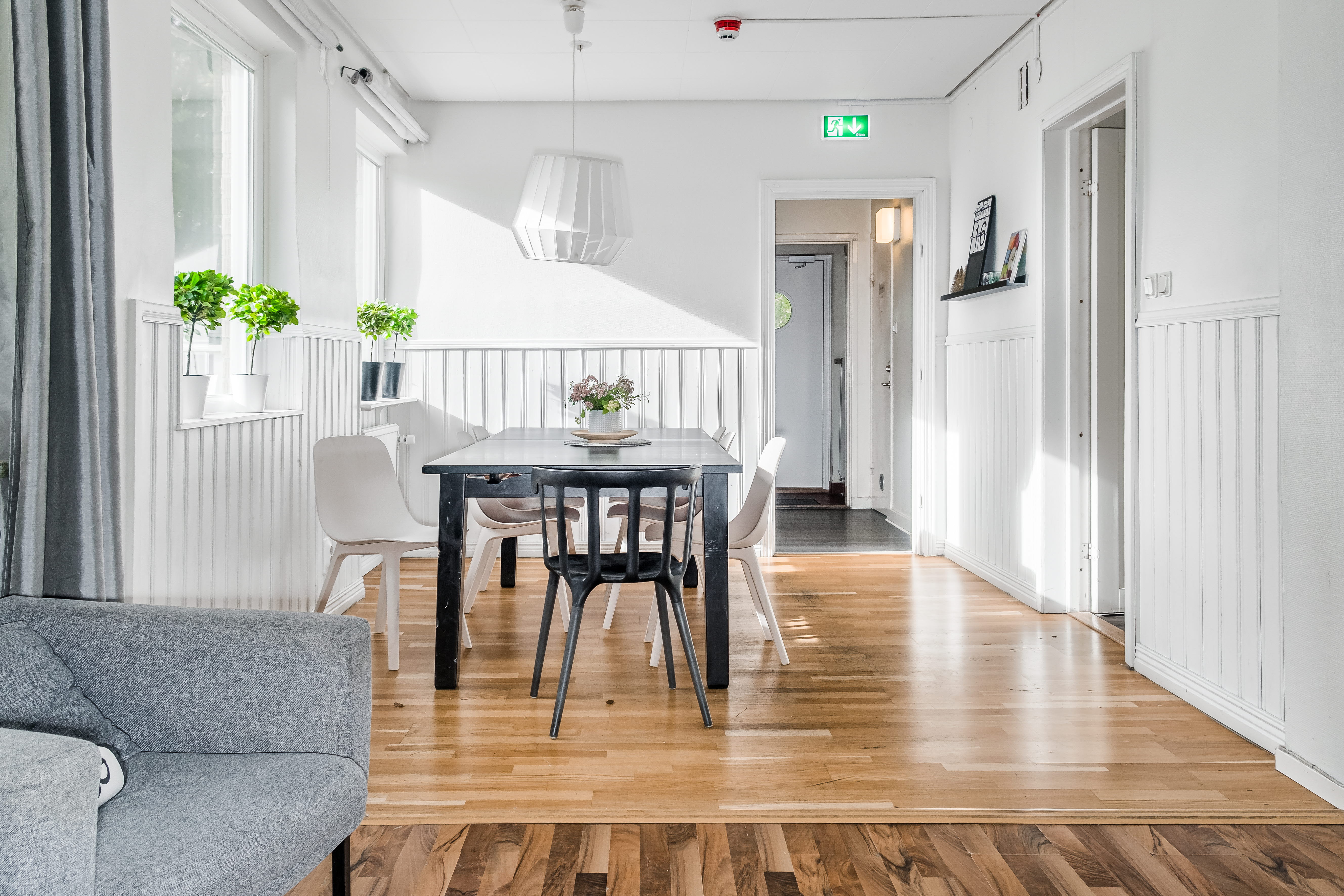 A living room filled with furniture on top of a hard wood floor