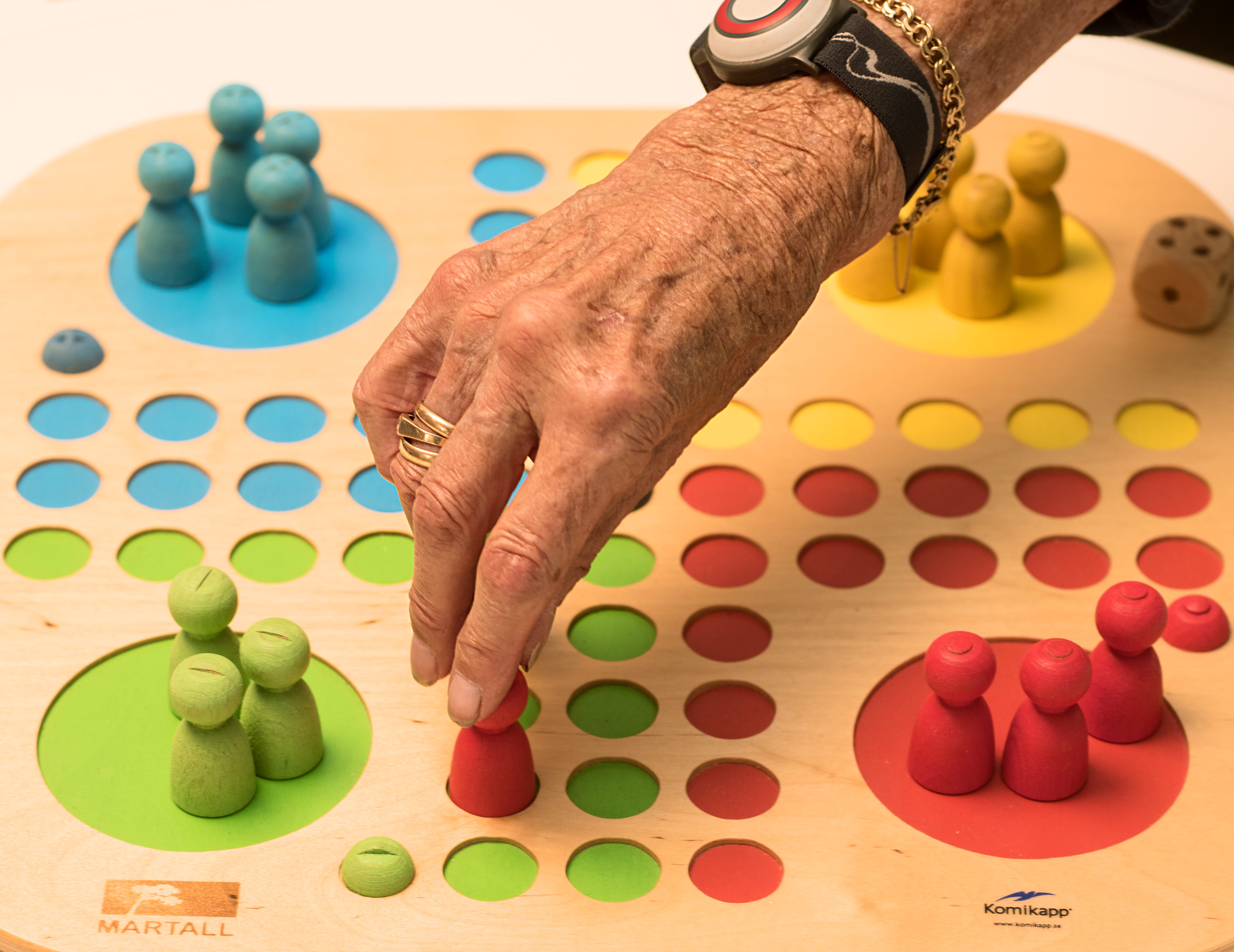 An elderly person is playing board games