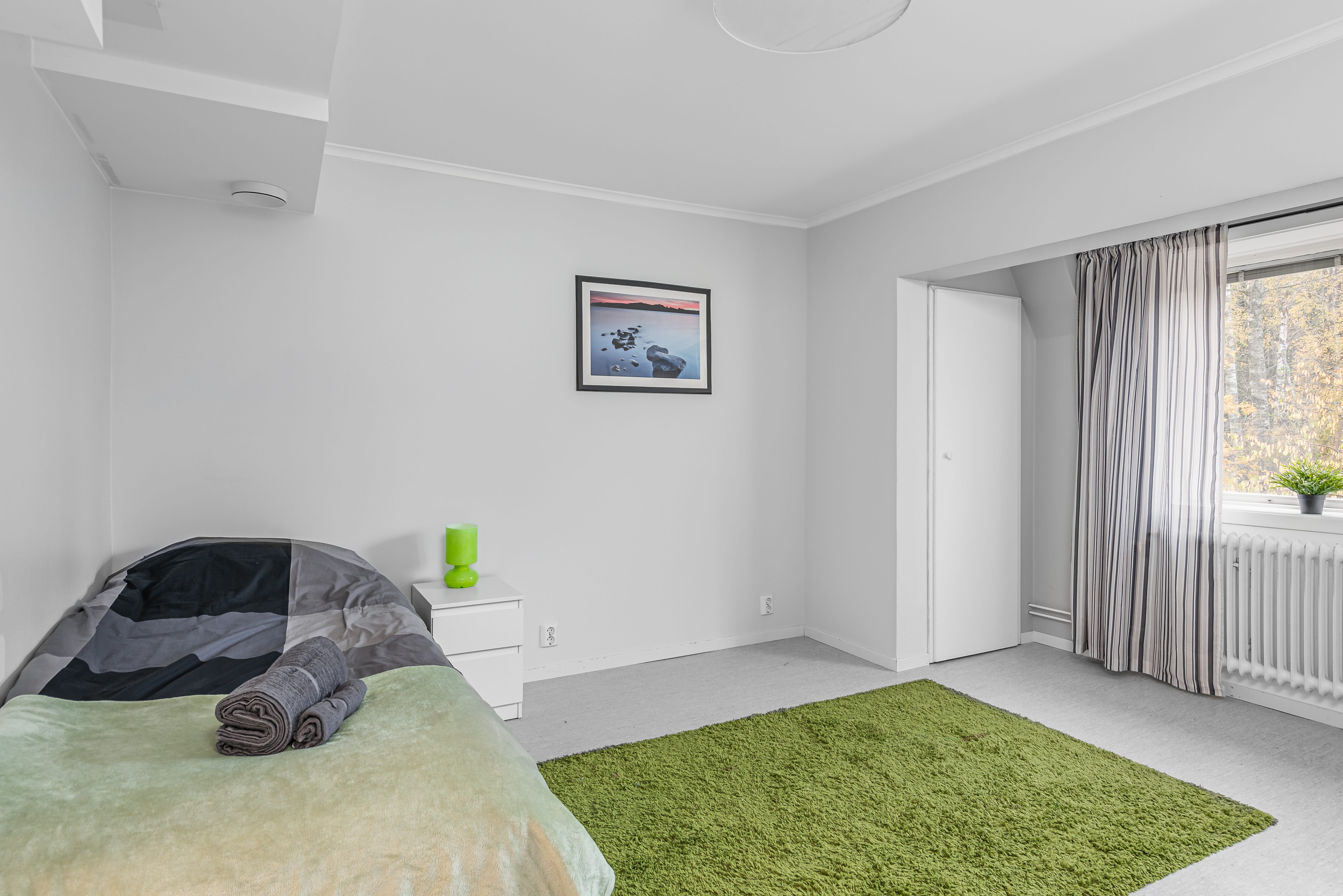 A bedroom with a bed in a room