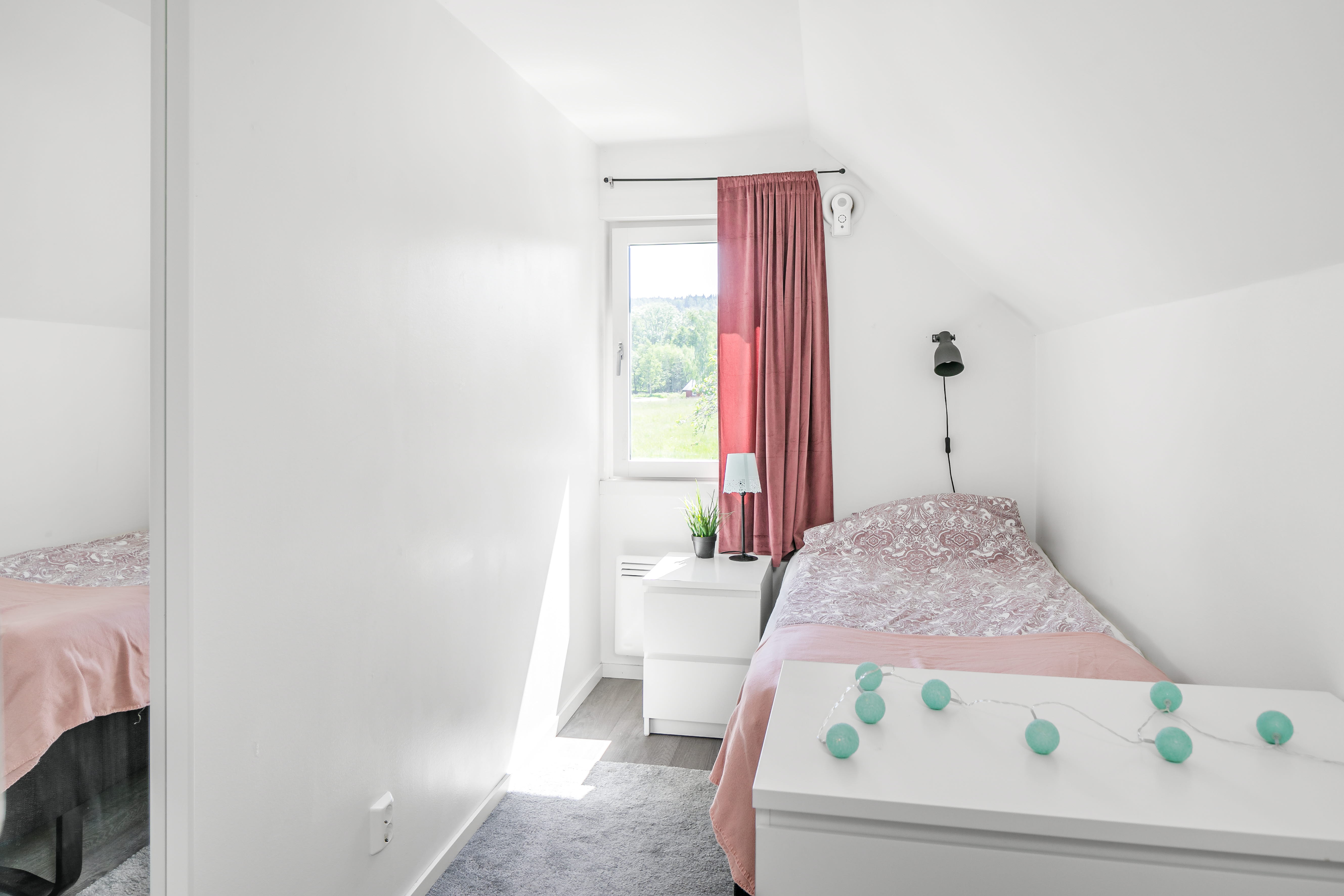 A bedroom with a bed in a room