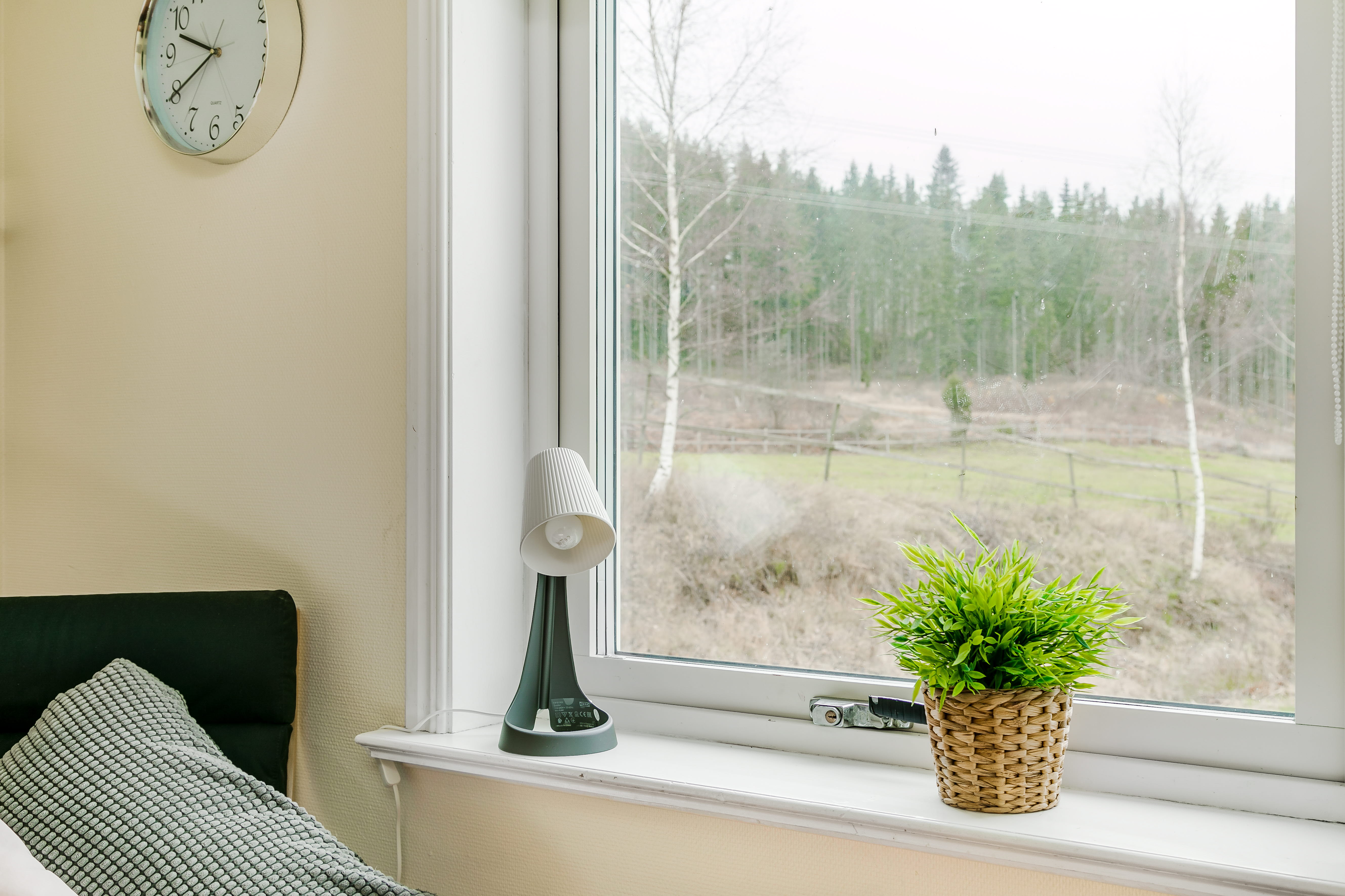 A clock sitting in front of a window