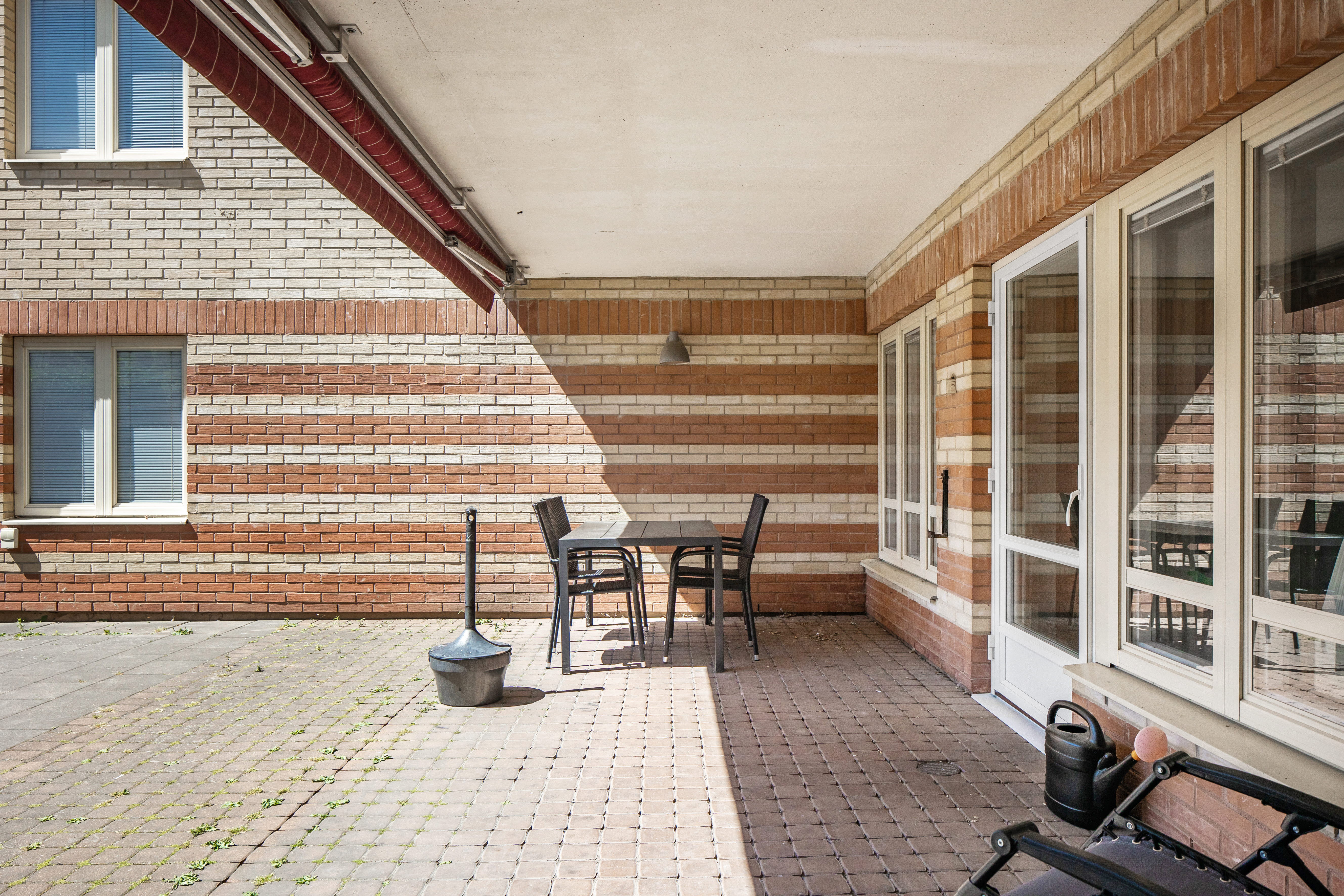 A chair sitting in front of a brick building