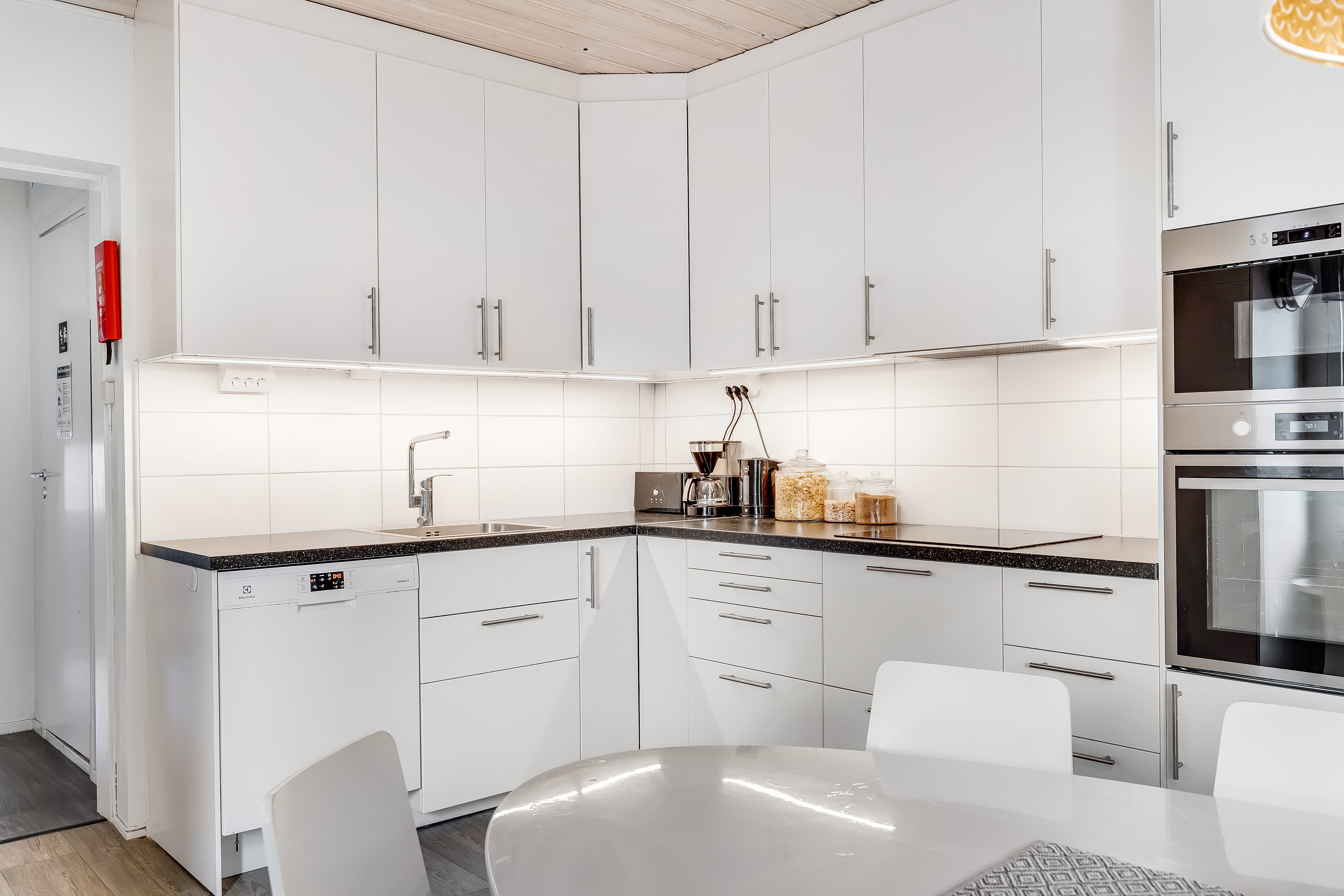 A kitchen with a sink and a microwave
