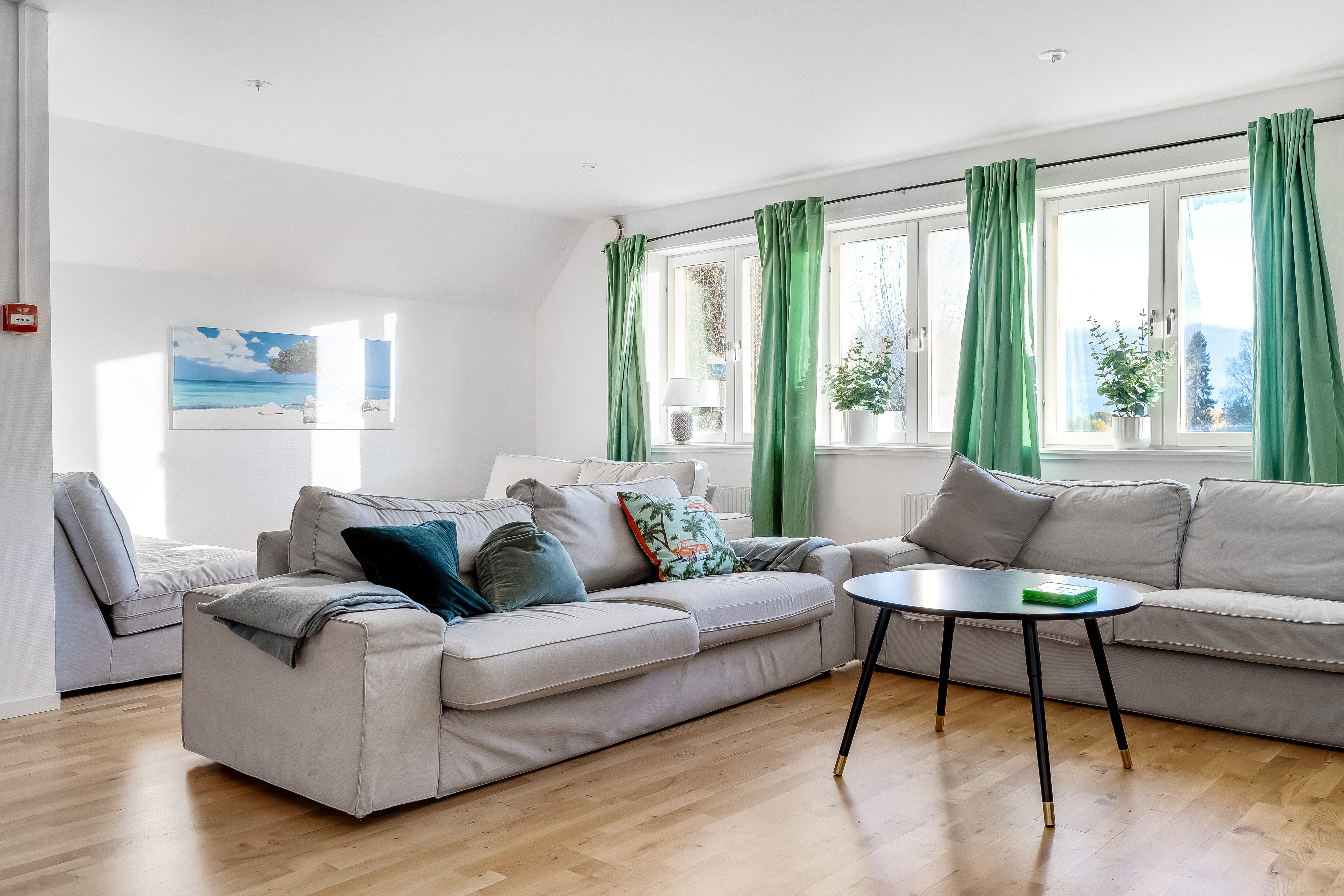 A living room filled with furniture and a large window