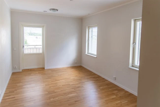 A large empty room with a hard wood floor