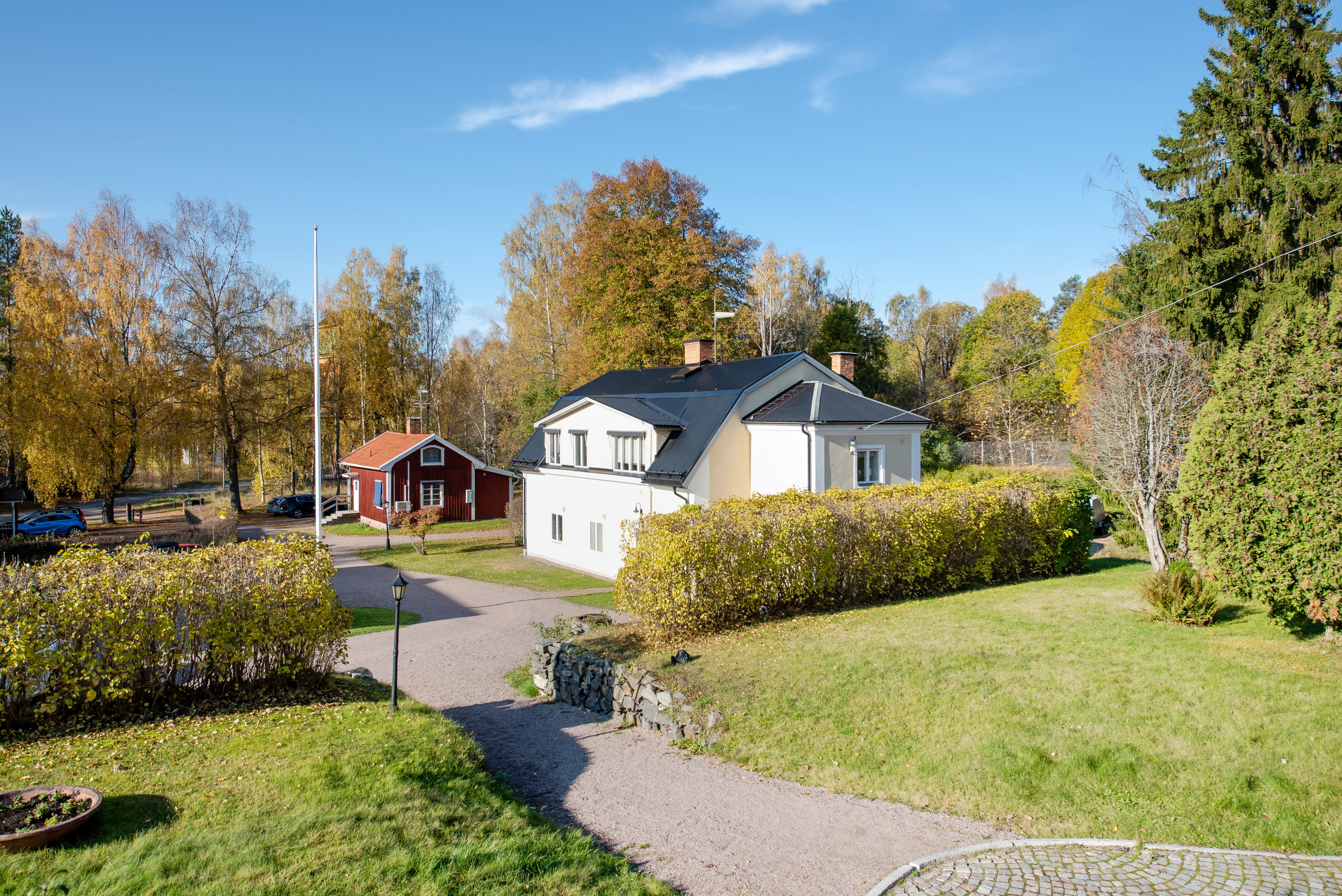 A path with trees on the side of a house