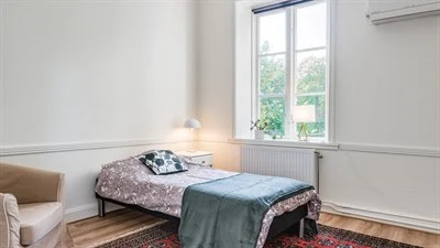 A bedroom with a large window