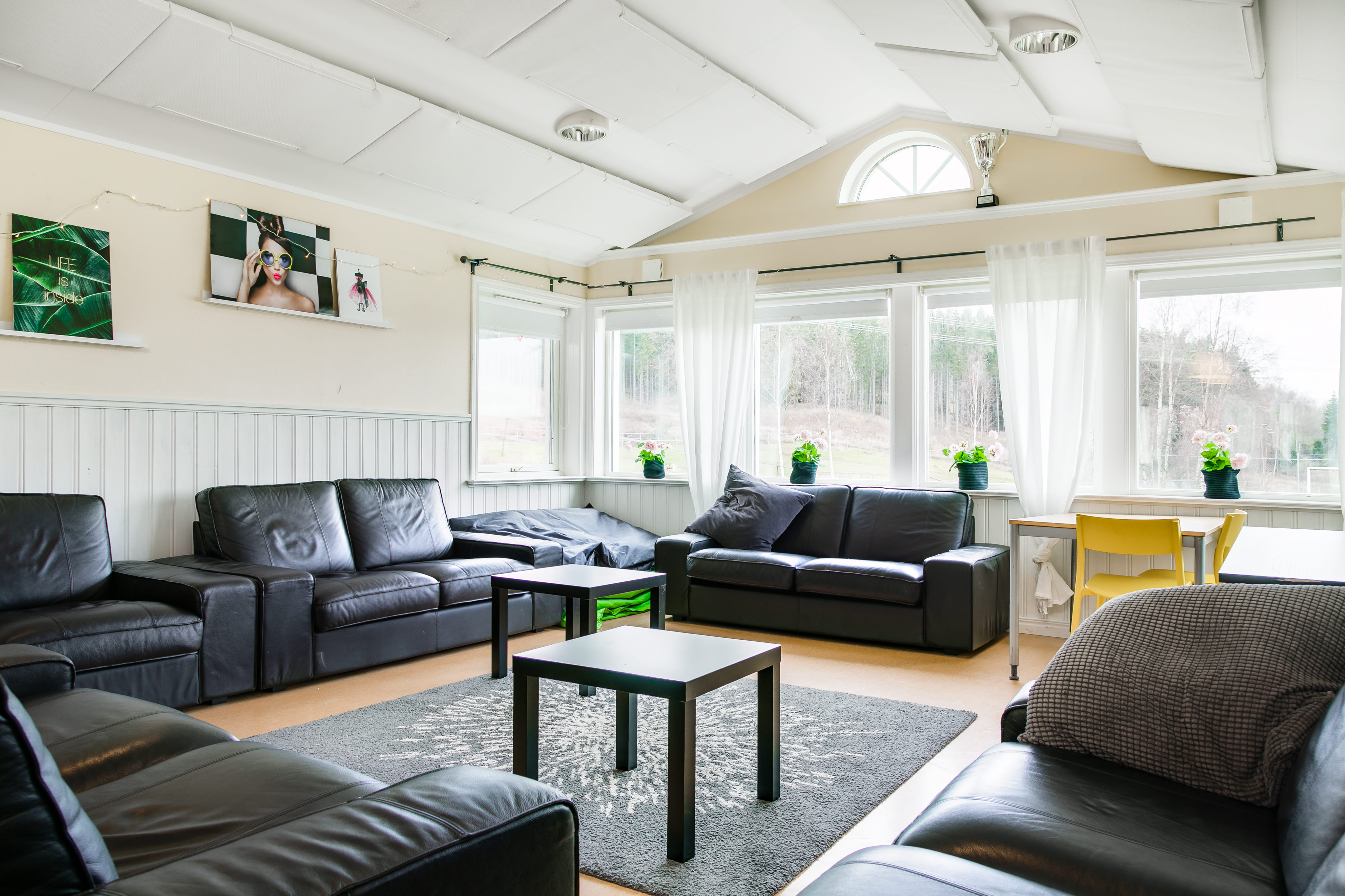 A living room filled with furniture and a large window