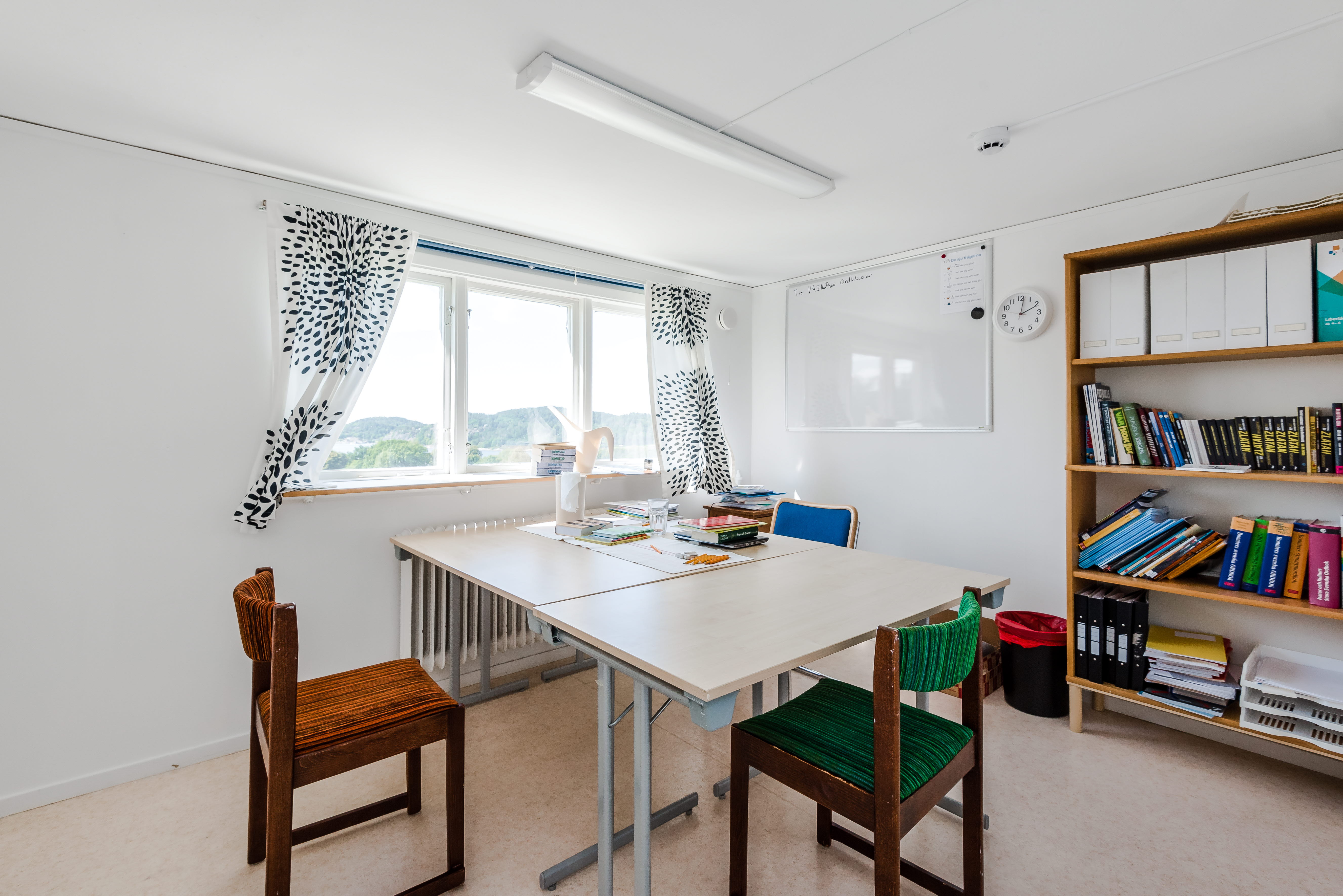 A kitchen with a table in a room