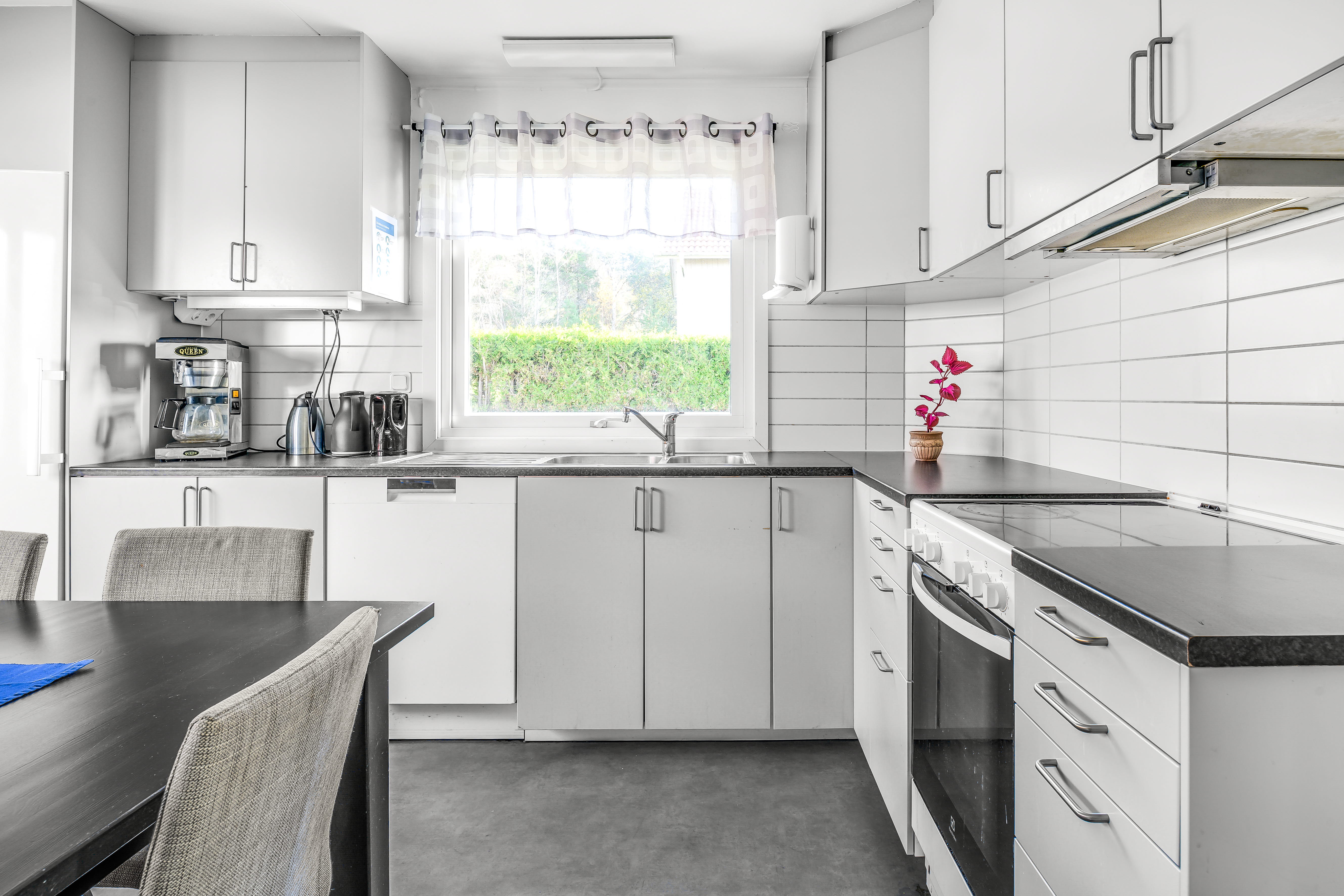 A kitchen with a table in a room