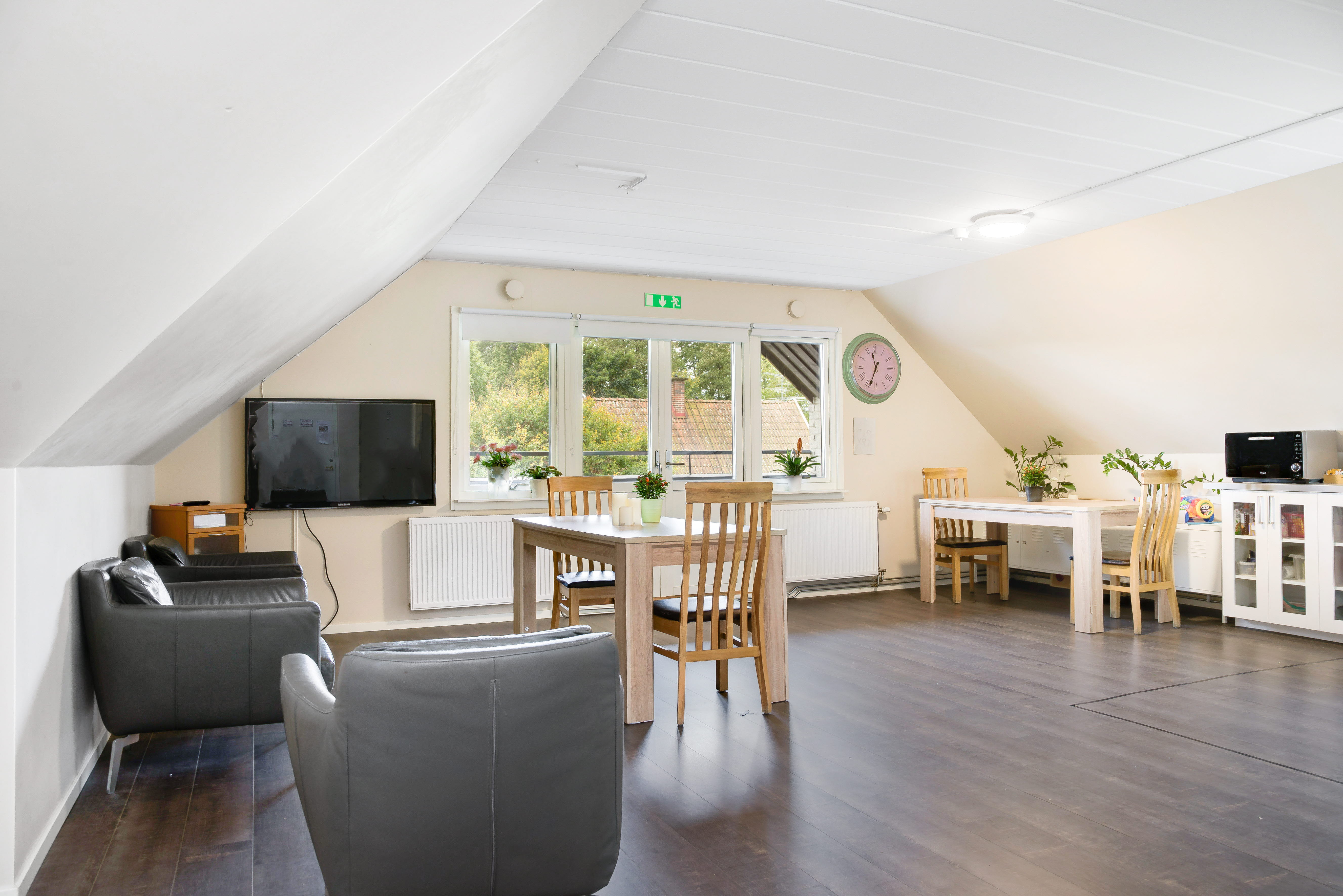 A living room filled with furniture and a wood floor