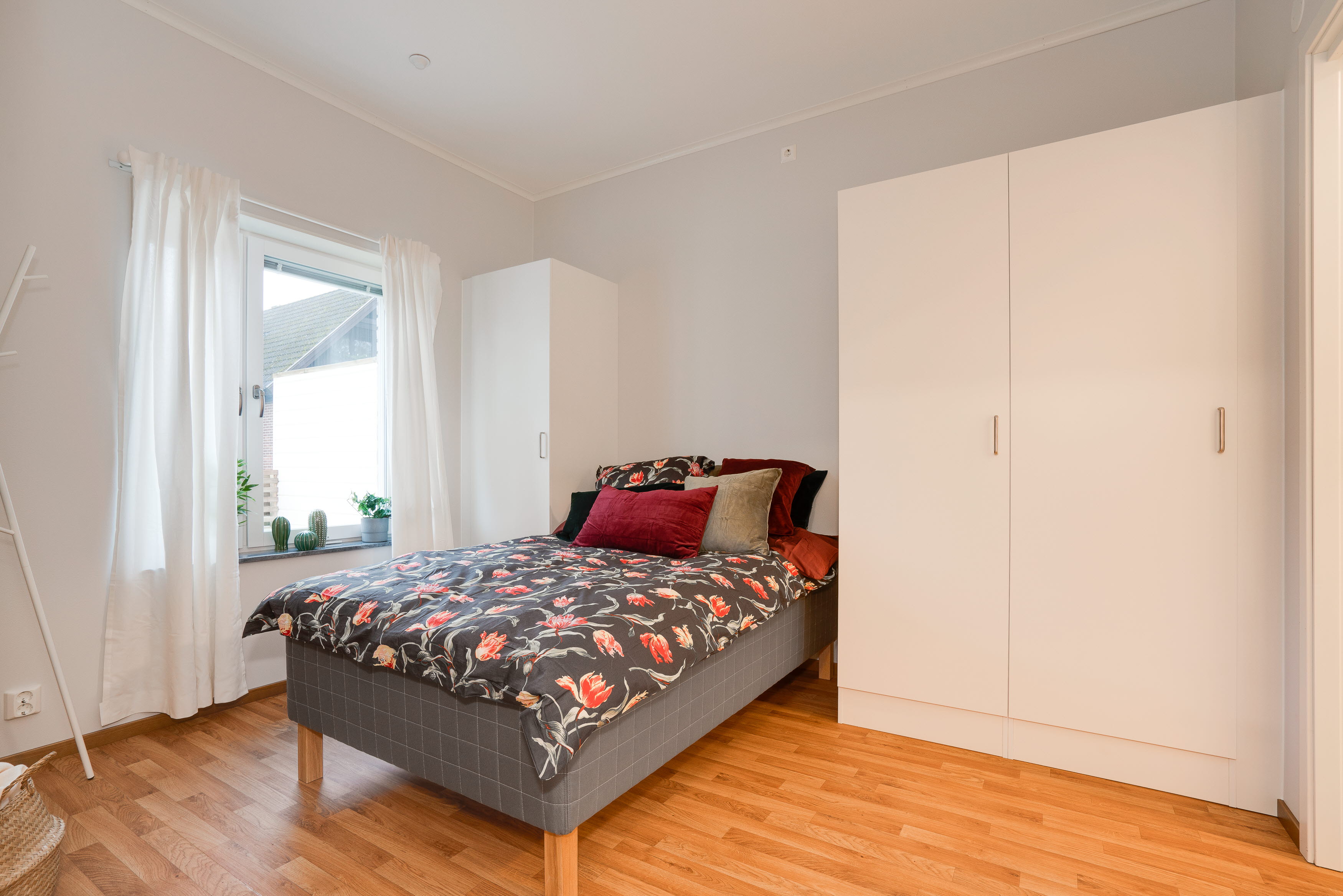 A bedroom with a wood floor