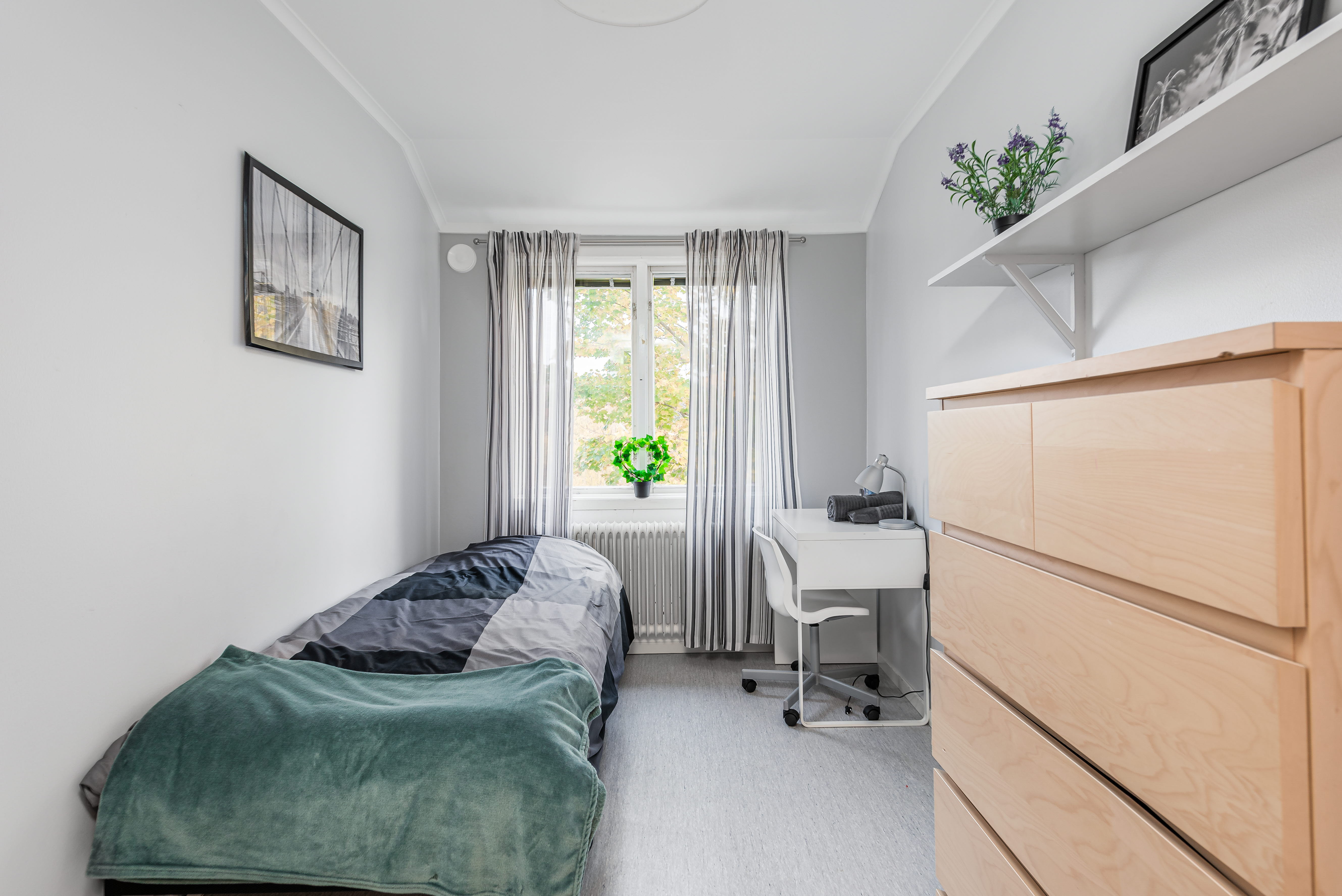 A bedroom with a bed in a room